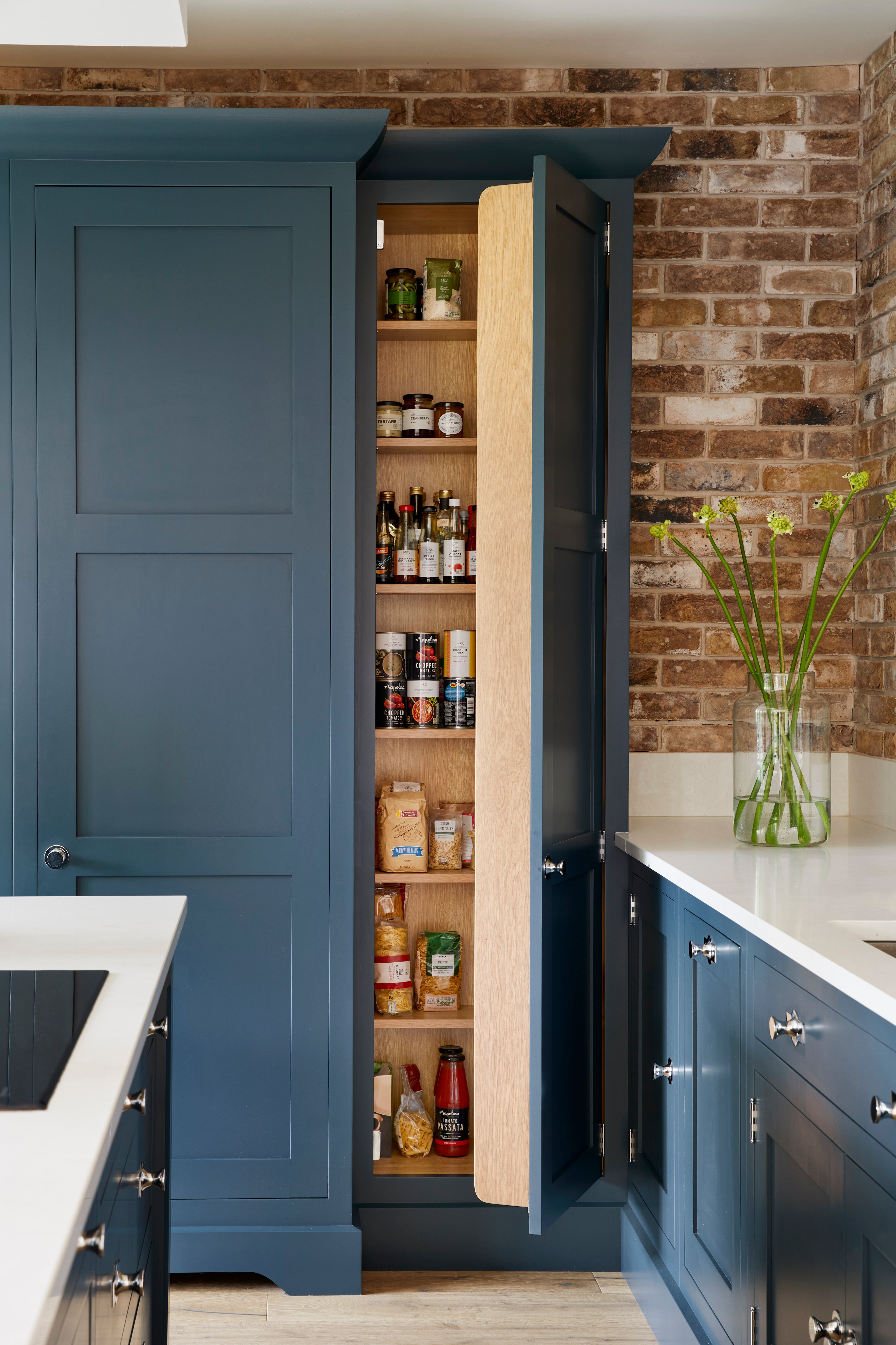 Consider offsetting dark coloured cabinets with glossy white worktops