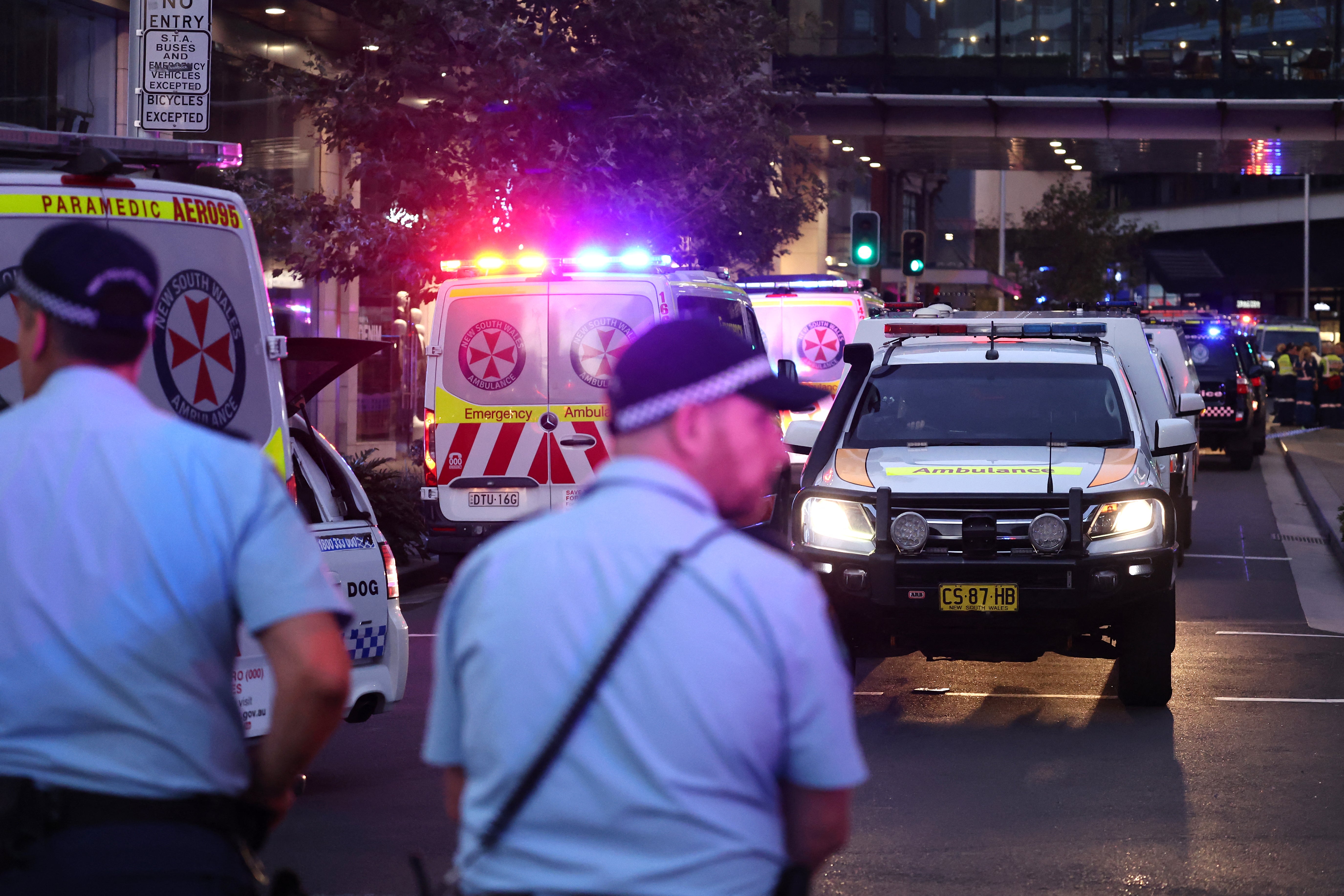 Ambulances make their way outside the Westfield Bondi Junction shopping mall after a stabbing incident in Sydney on 13 April 2024