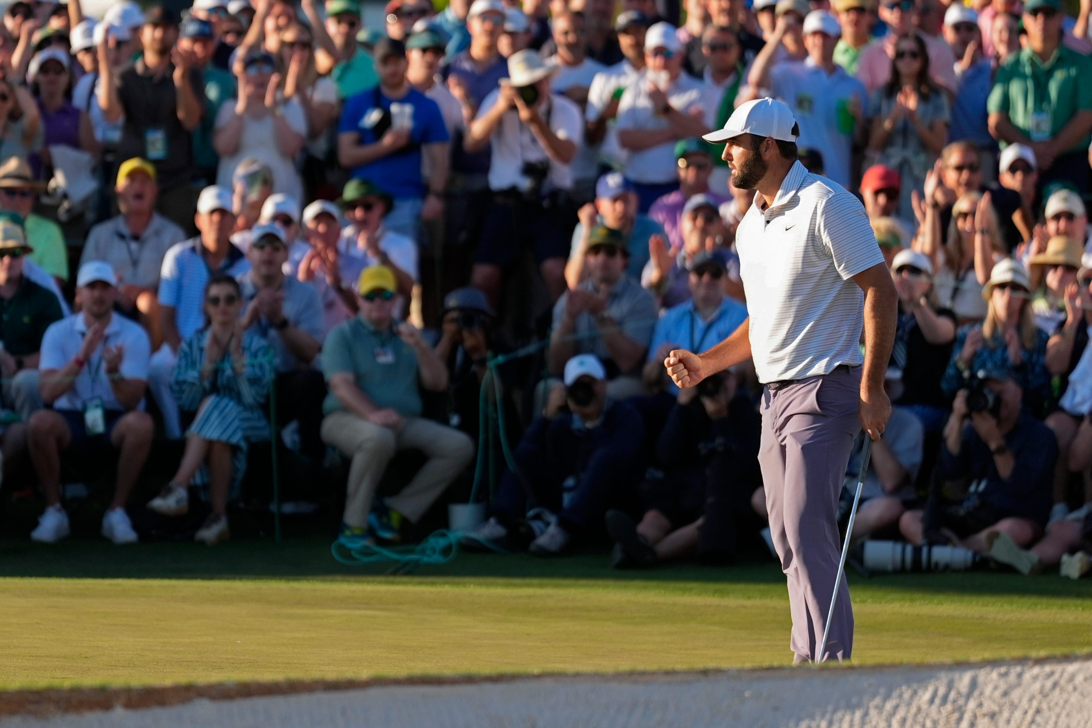 Scottie Scheffler celebrates after a birdie on the 18th hole gave him a one-shot lead after 54 holes of the Masters (Ashley Landis/AP)