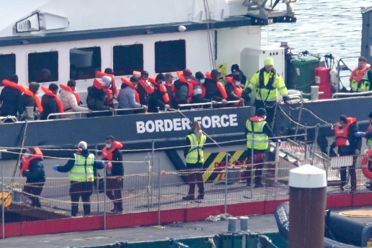 A group of people thought to be migrants are brought in to Dover (PA)