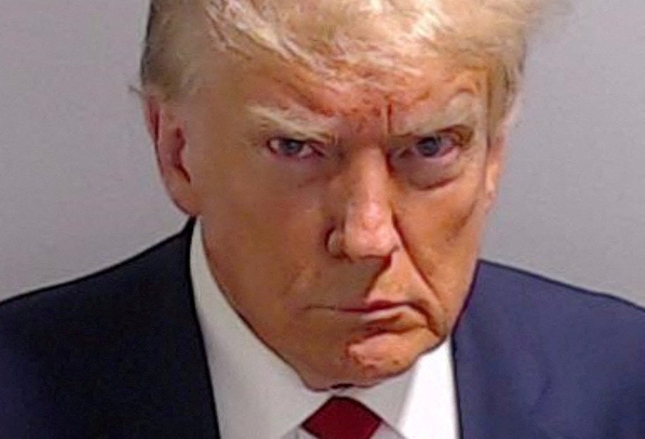 Donald Trump said that he has received more support from the Black and Hispanic communities after he took his mugshot, pictured, in Fulton County, Georgia