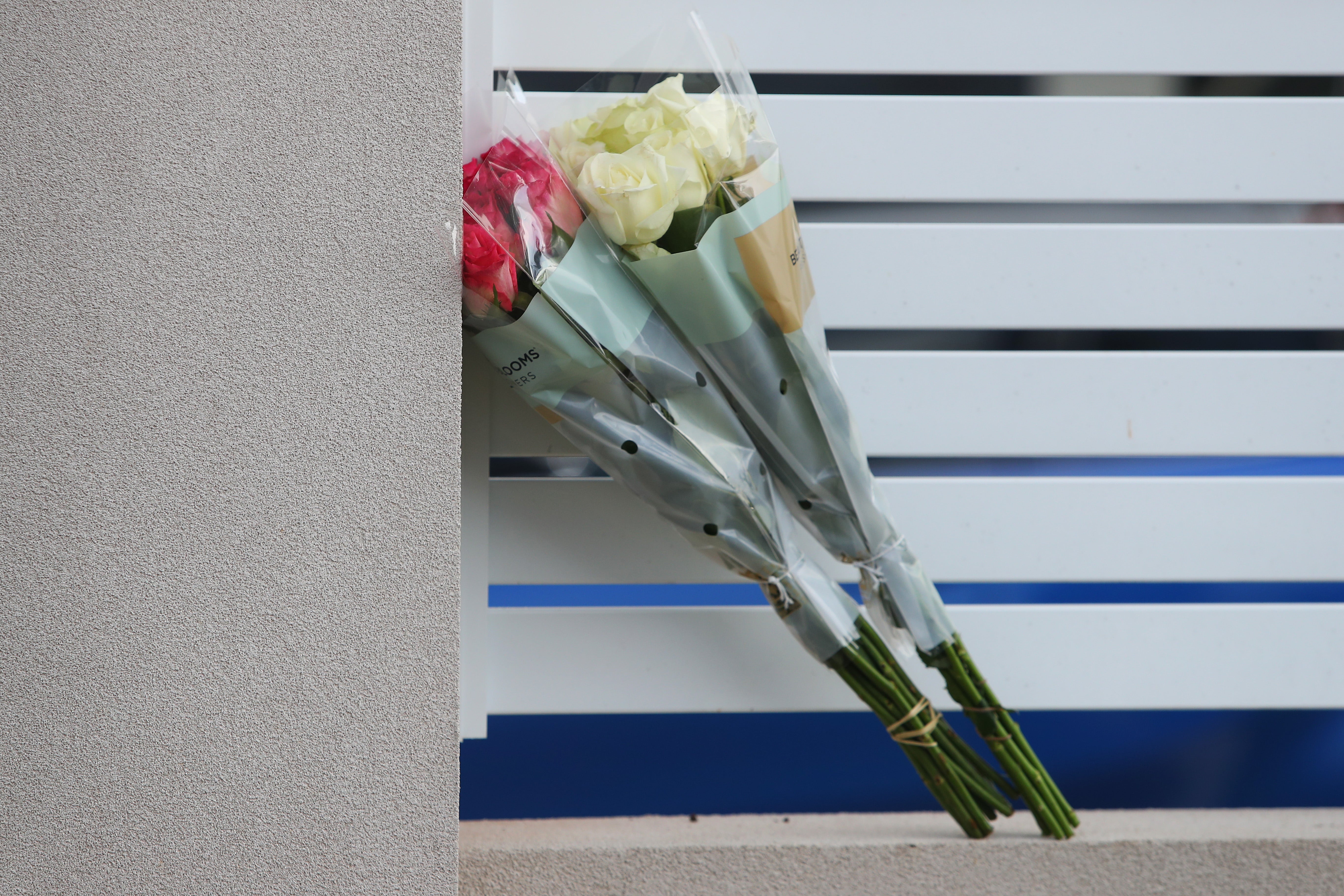 Flowers delivered by a member of the public rest against a fence at Christ The Good Shepherd Church in the suburb of Wakeley on 16 April 2024 in Sydney, Australia