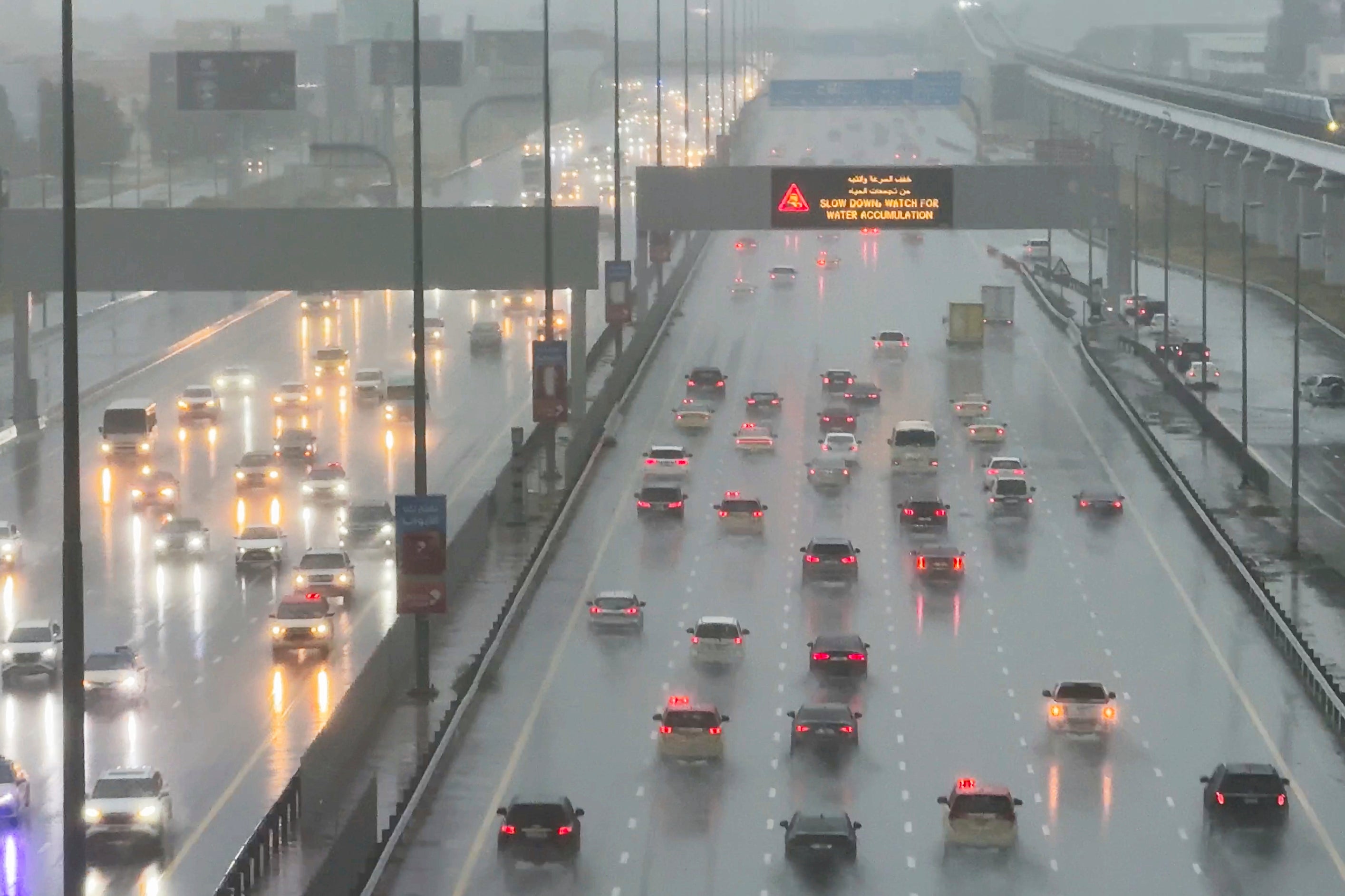 Vehicles drive through heavy rain on the Sheikh Zayed Road highway in Dubai, United Arab Emirates, Tuesday, April 16, 2024