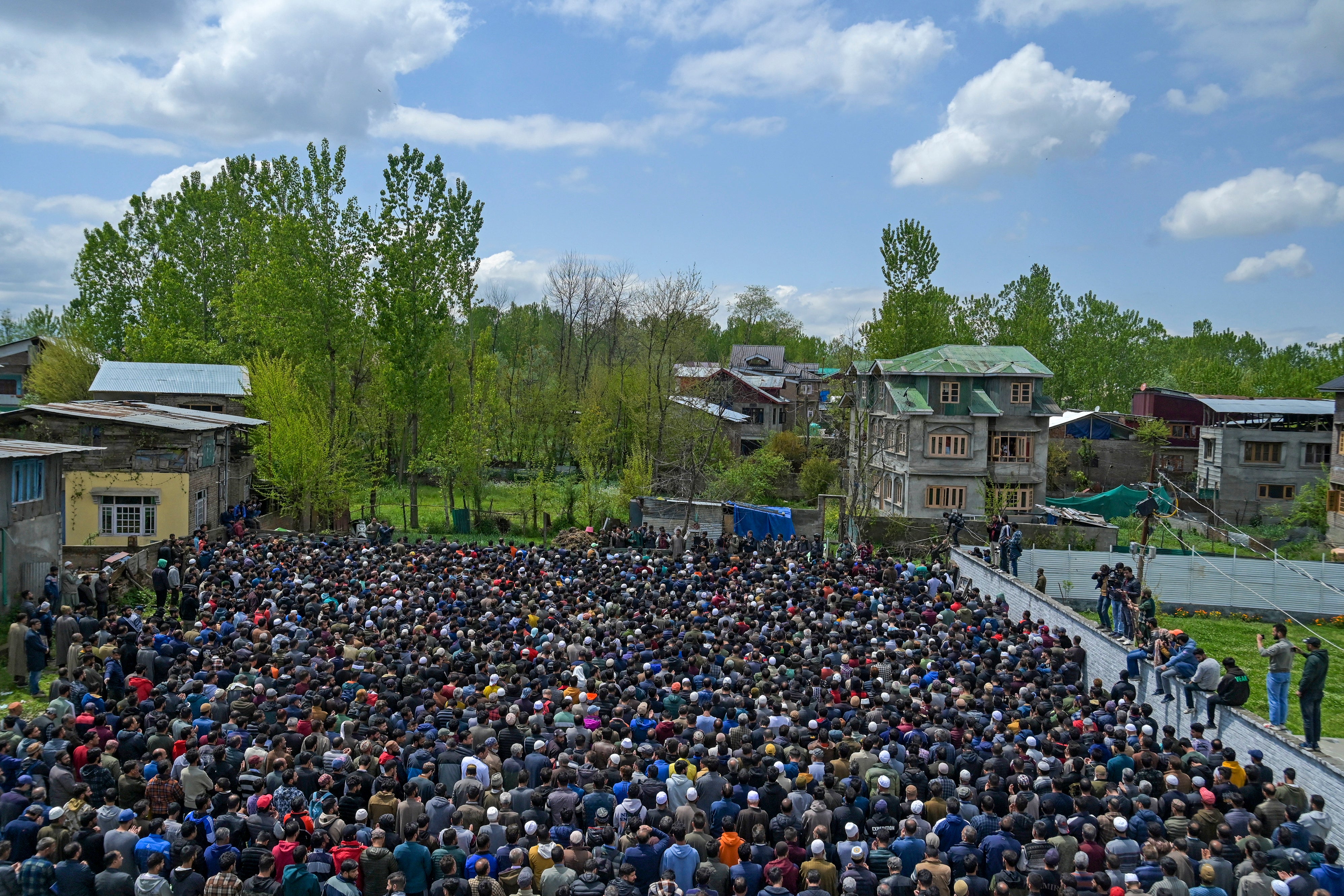 People carry coffins of victims who died after a boat overturned in the Jhelum river in Srinagar