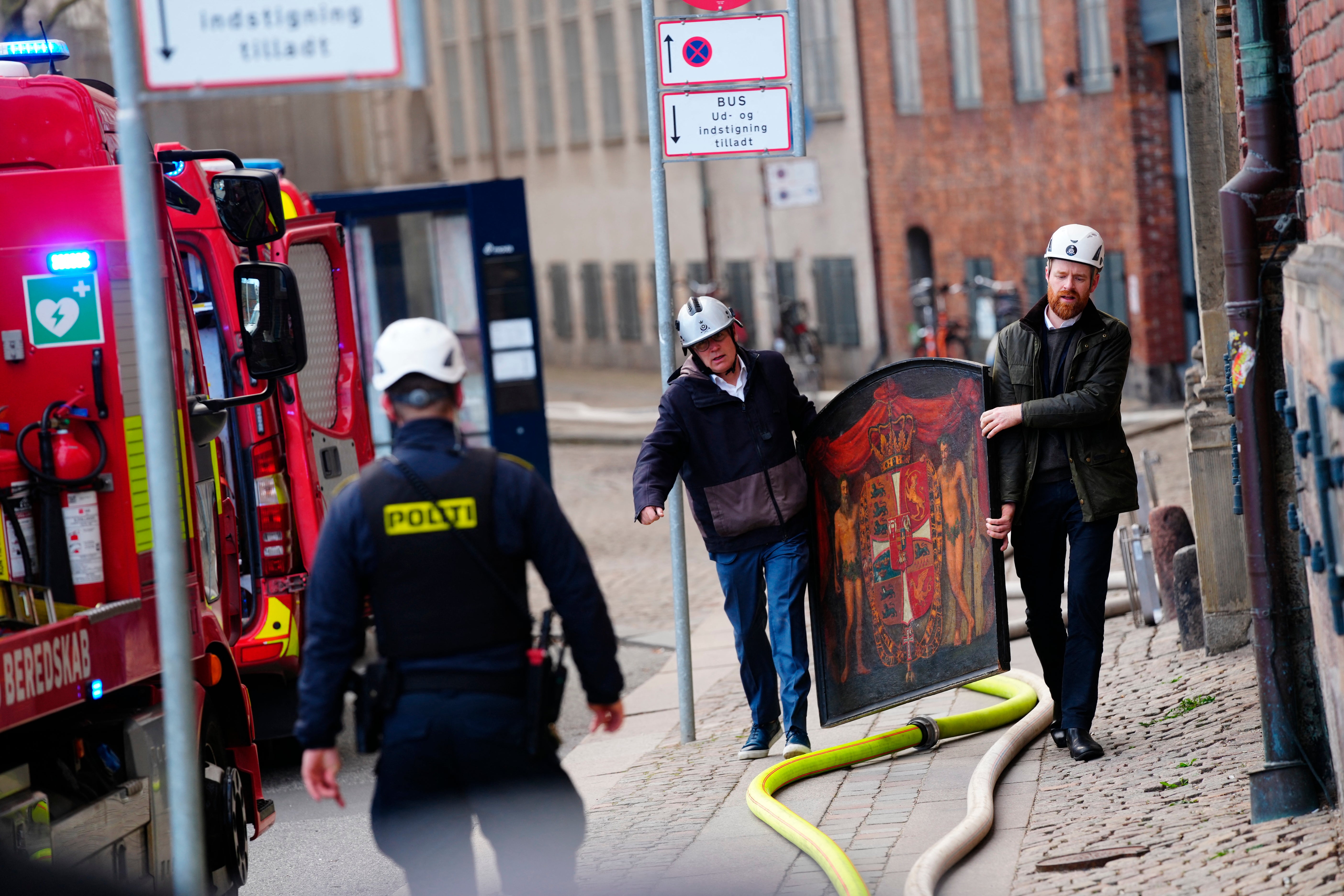 A painting is salvaged from the flames of the Boersen stock exchange building in Copenhagen during Tuesday’s fire