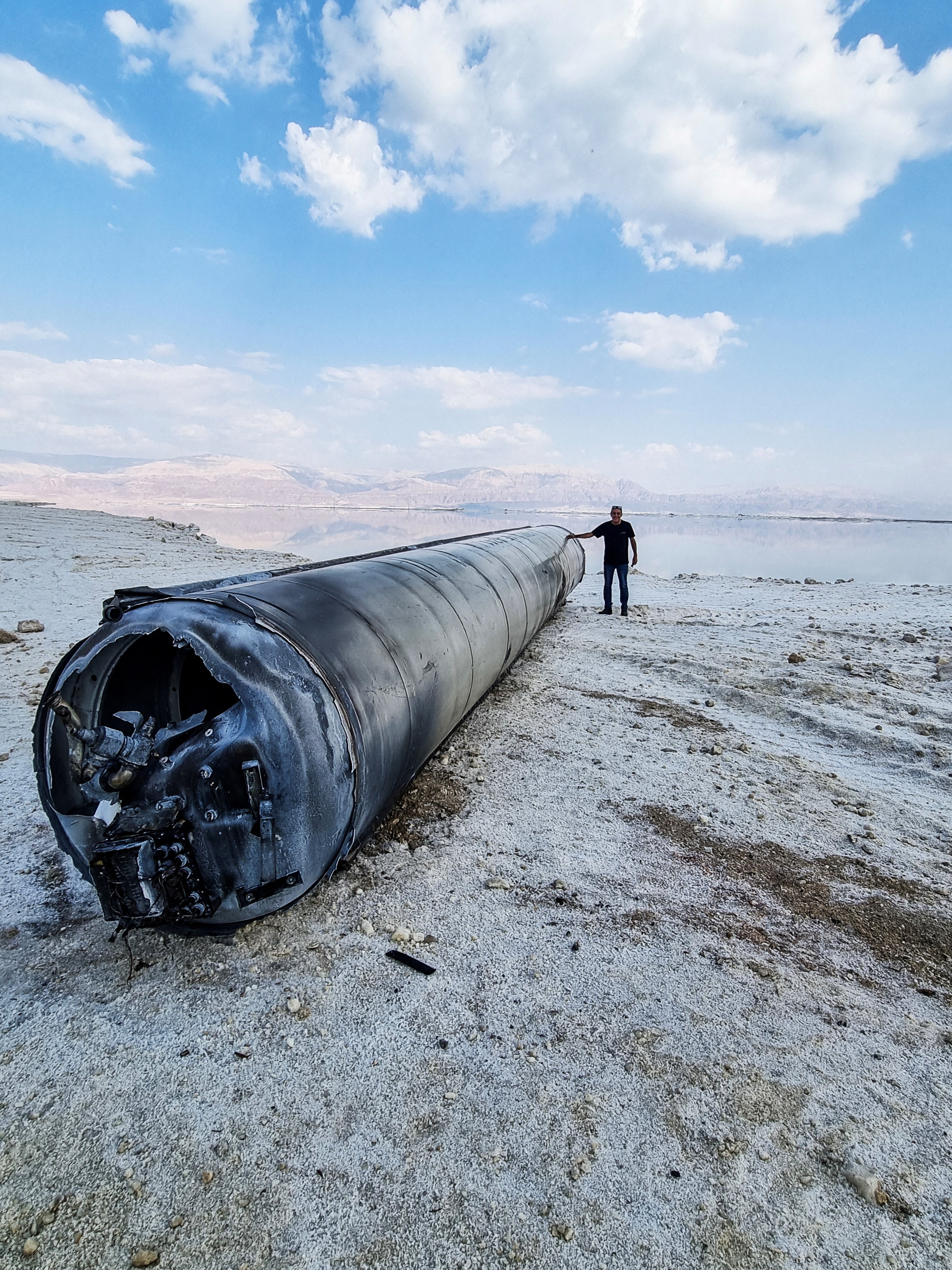 A ballistic missile lies on the shore of the Dead Sea after Iran launched drones and missiles towards Israel