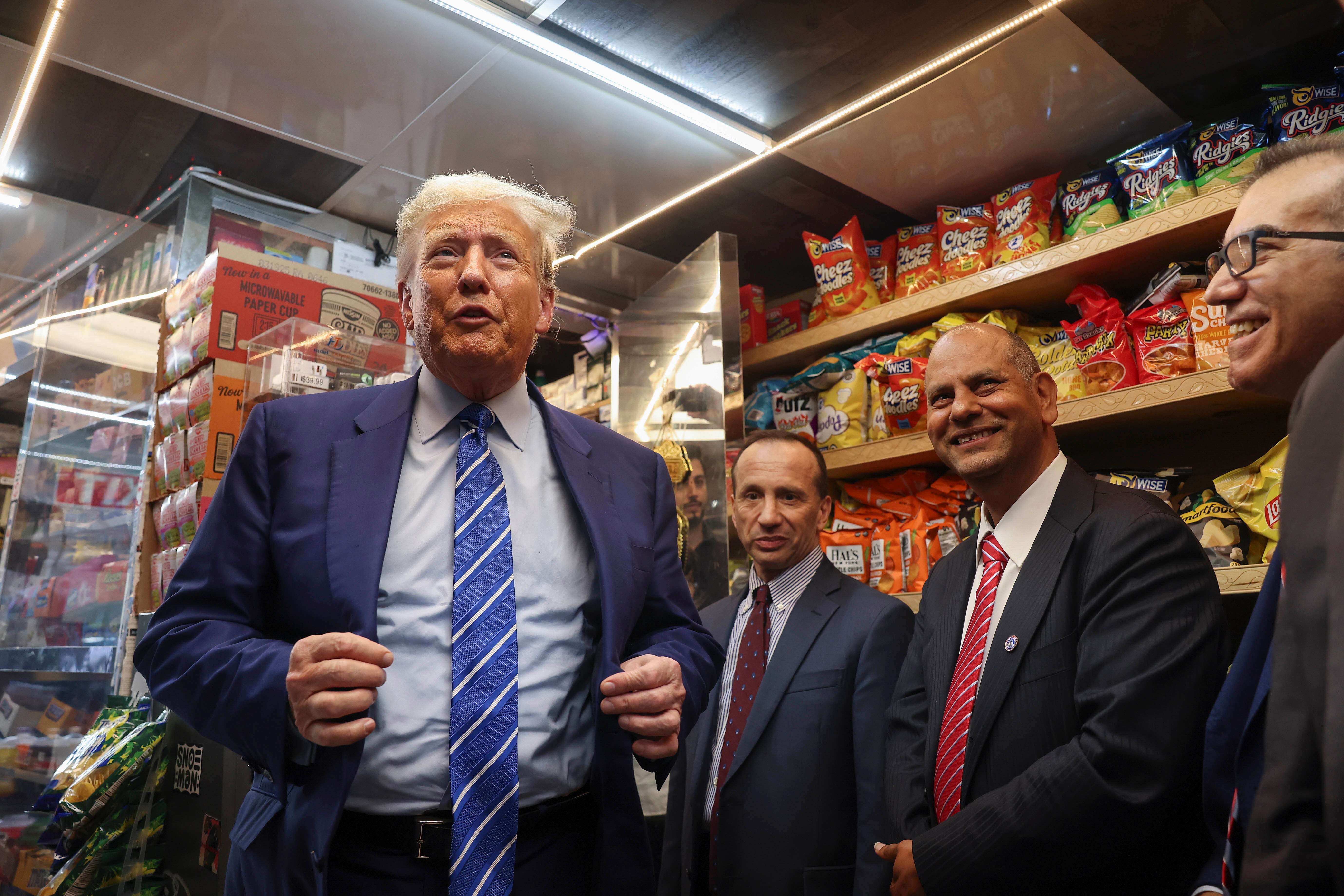 Former president Donald Trump, left, visited the bodega where Jose Alba (not pictured), the store's former owner, was attacked in New York