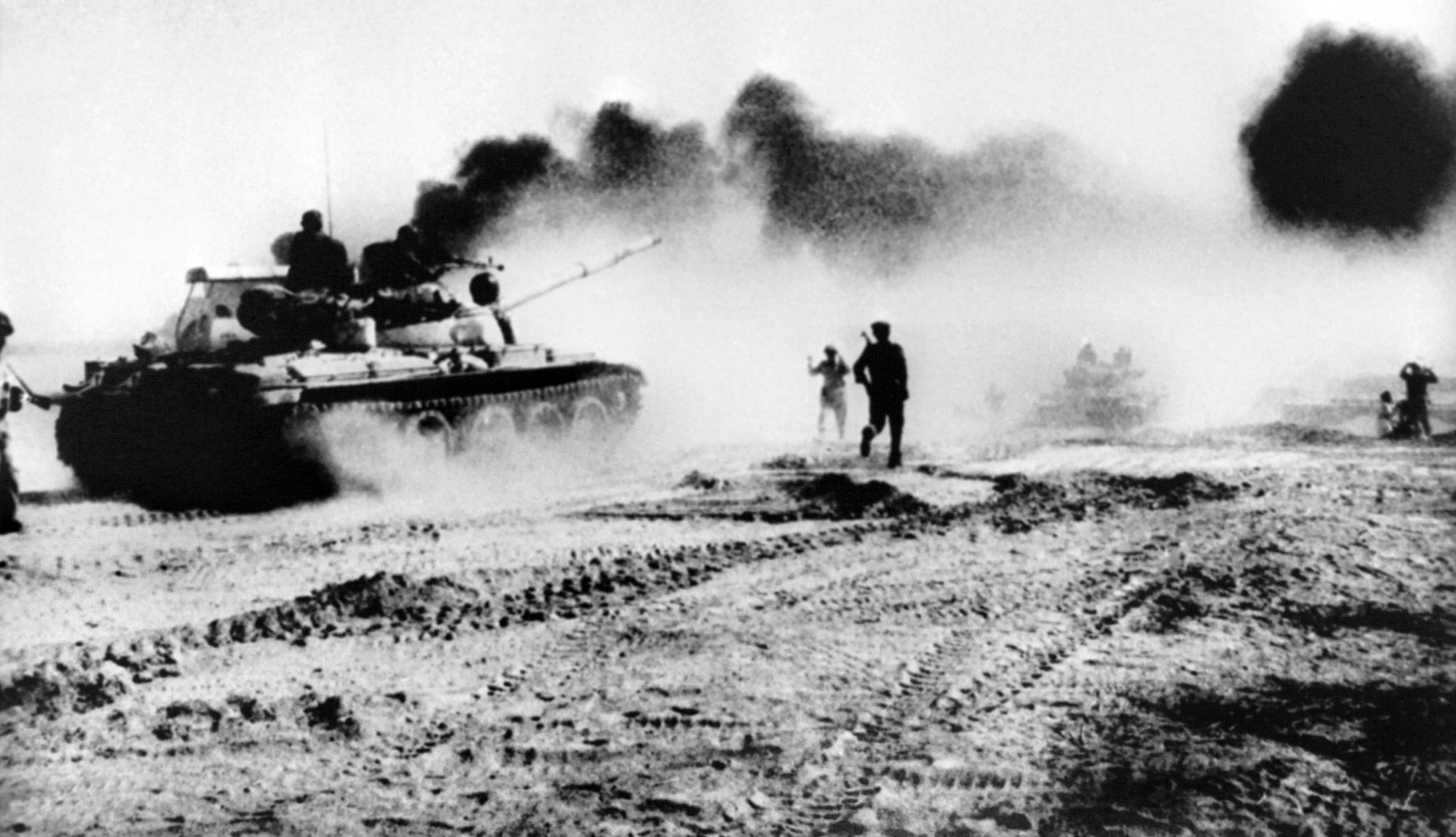 Iraqi troops in 1980 riding in Soviet-made tanks try to cross the Karun river in Iran