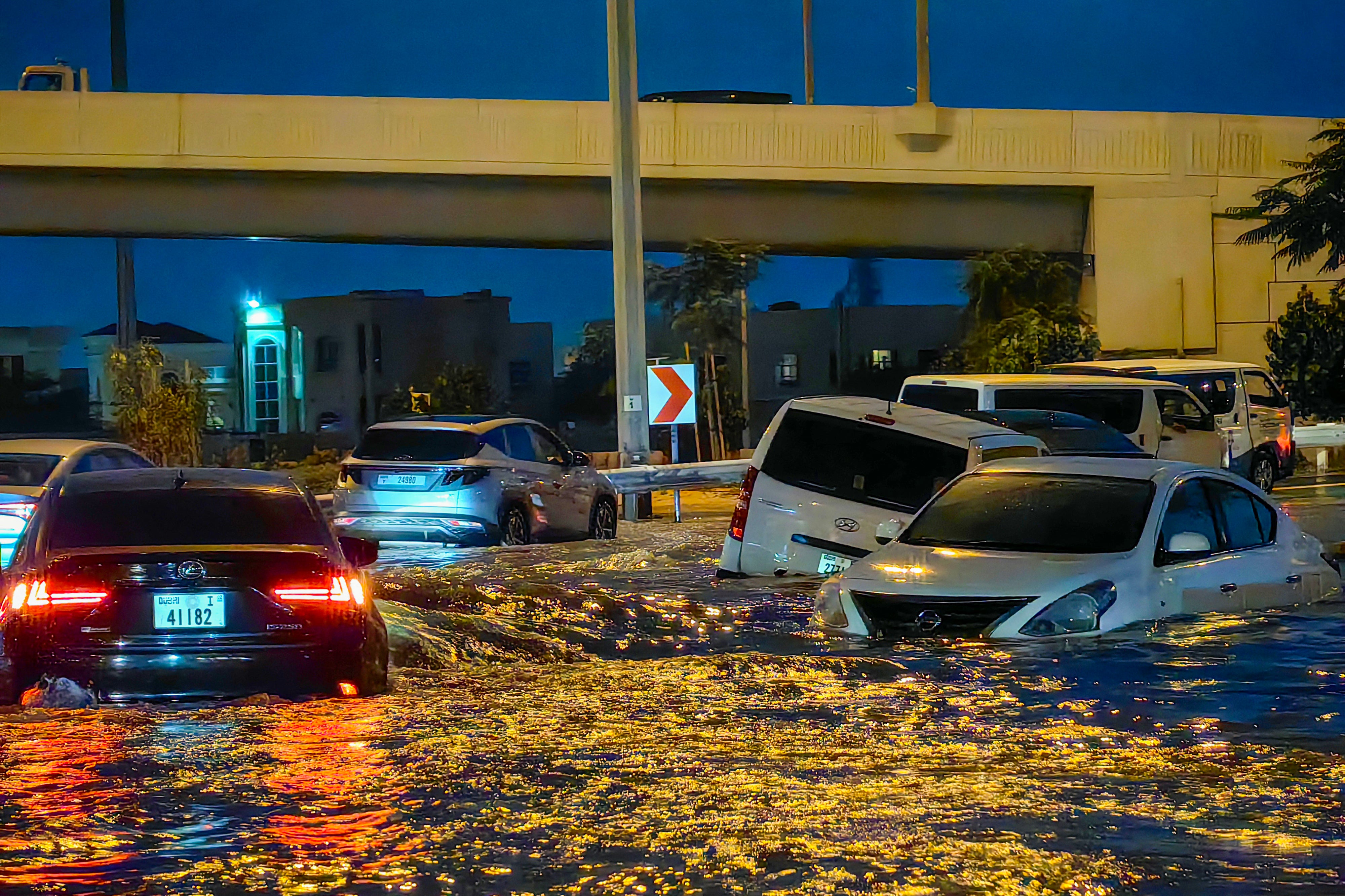 Cars drive in a flooded street following heavy rains in Dubai