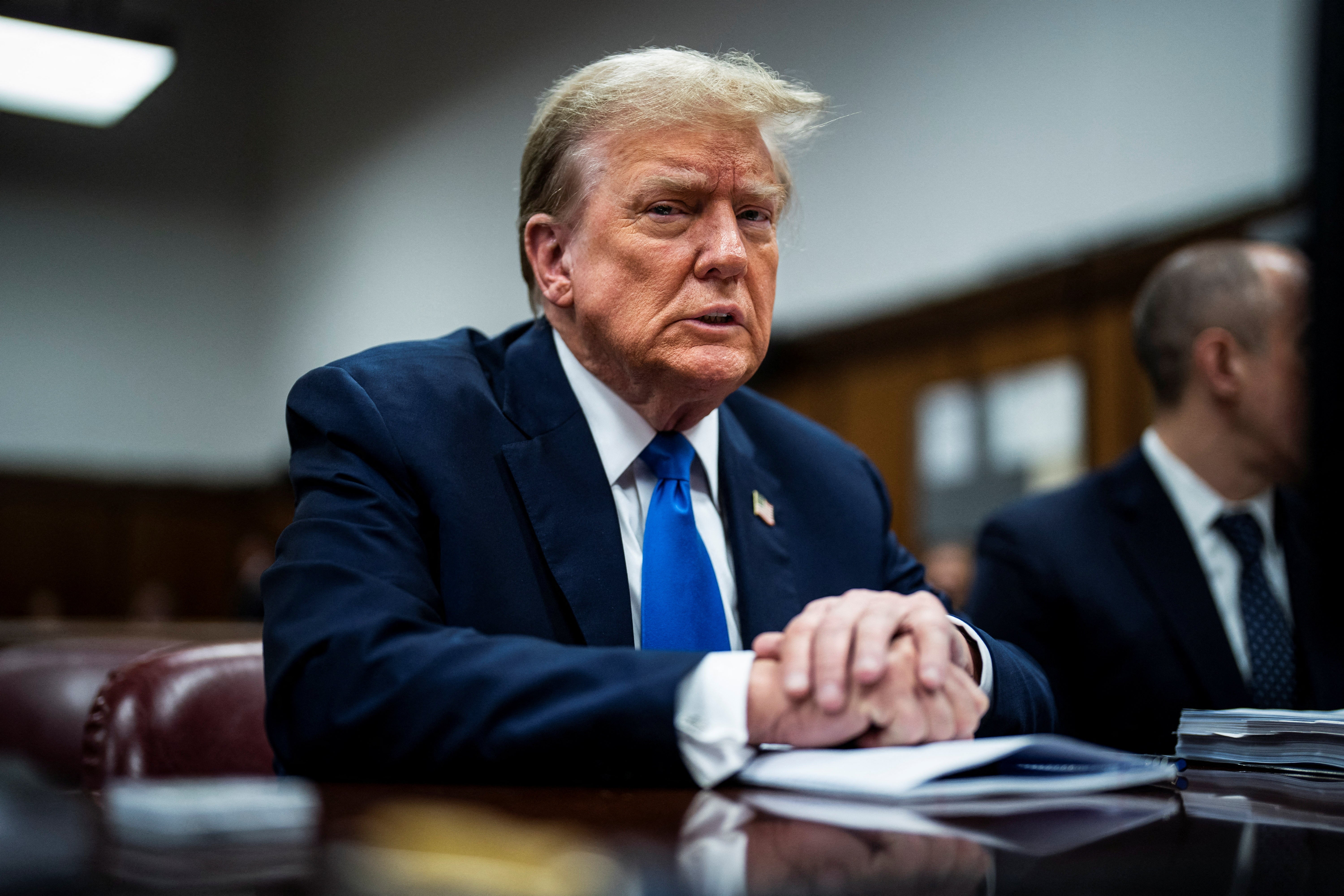 Former US president Donald Trump sits at the defence table at his criminal trial on charges of falsifying business records in New York