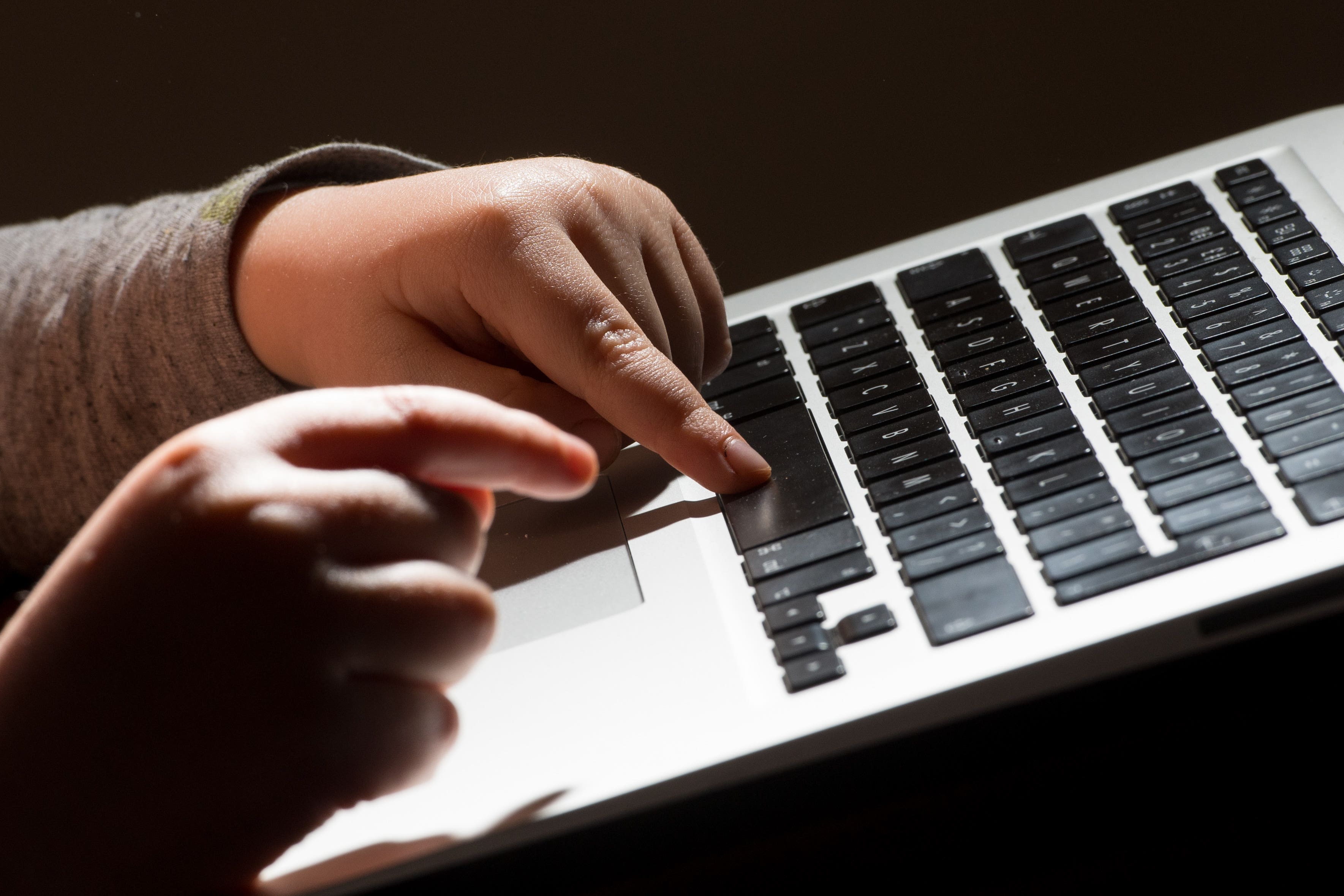 File photo dated 26/05/22 of a child using a laptop computer. Young people are contacting Childline about AI-generated child sexual abuse material, the NSPCC has said as it announced a new partnership aimed at championing child safety during the development of new AI technology. The children’s charity said young people had also contacted Childline about harm linked to generative AI, including the spread of misinformation and bullying. Issue date: Thursday January 25, 2024.