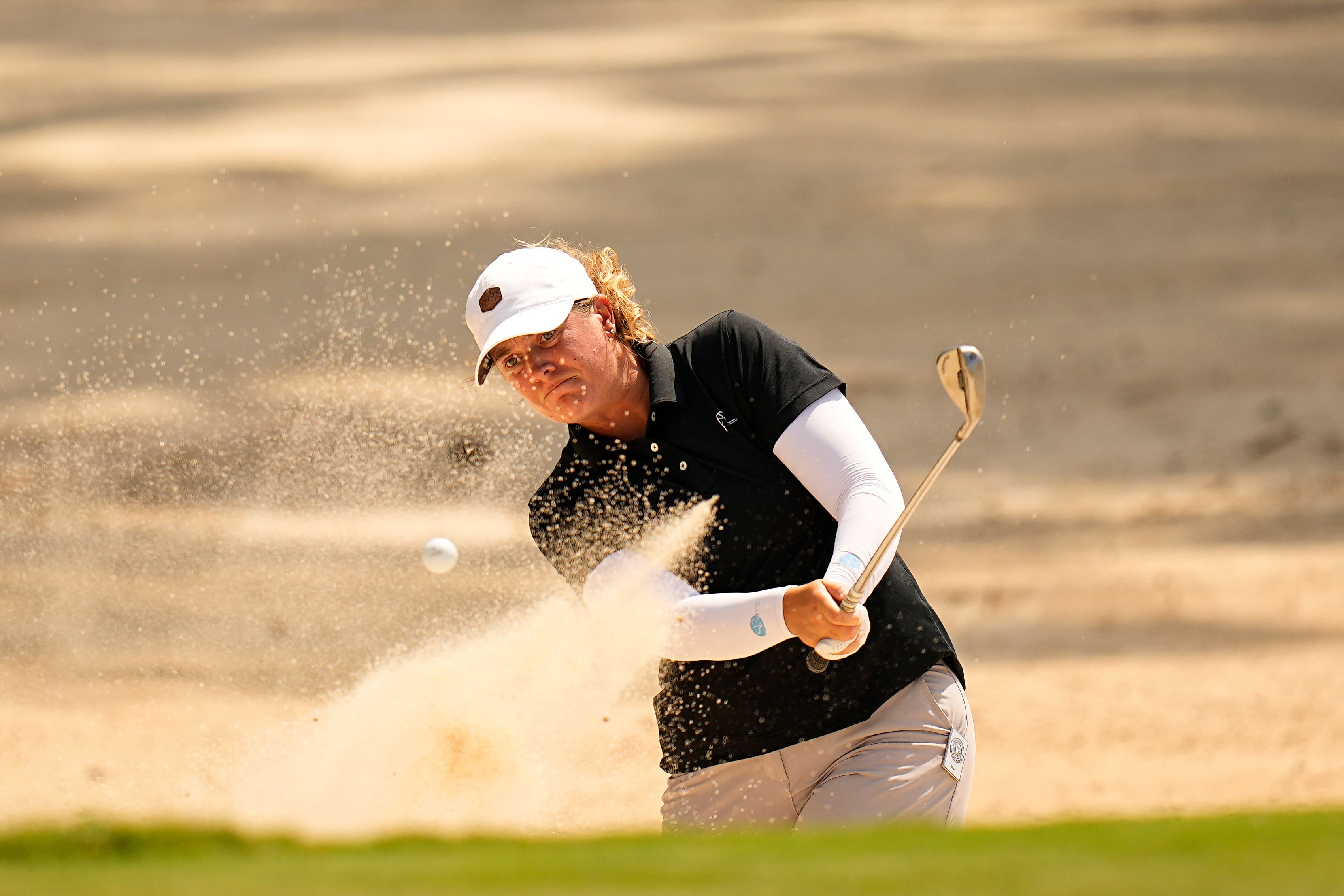 Lauren Coughlin hit from the bunker on the eighth green during the first round at the Chevron Championship (Eric Gay/AP)