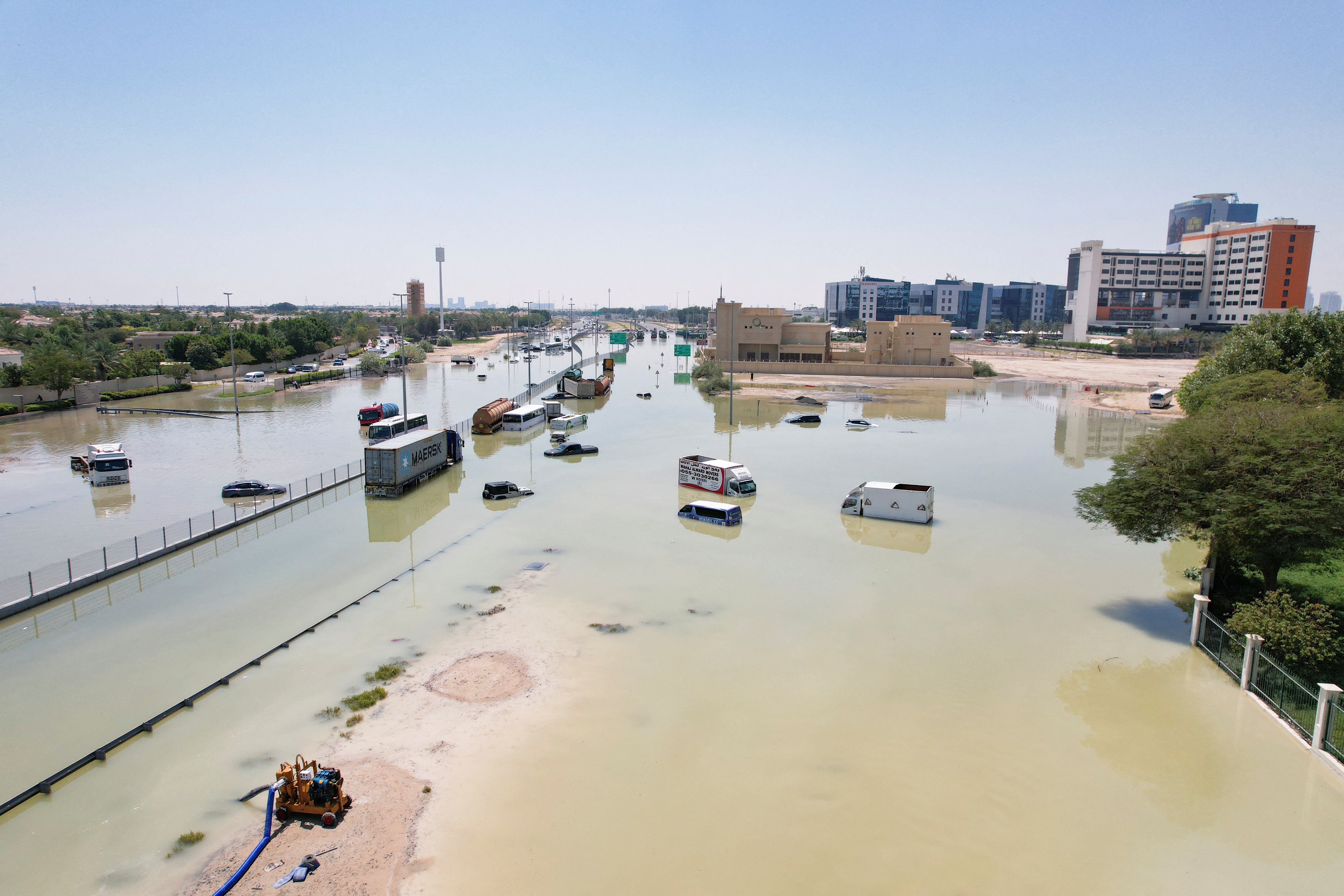 A drone view of cars and trucks lying partially submerged following heavy rainfall in Dubai