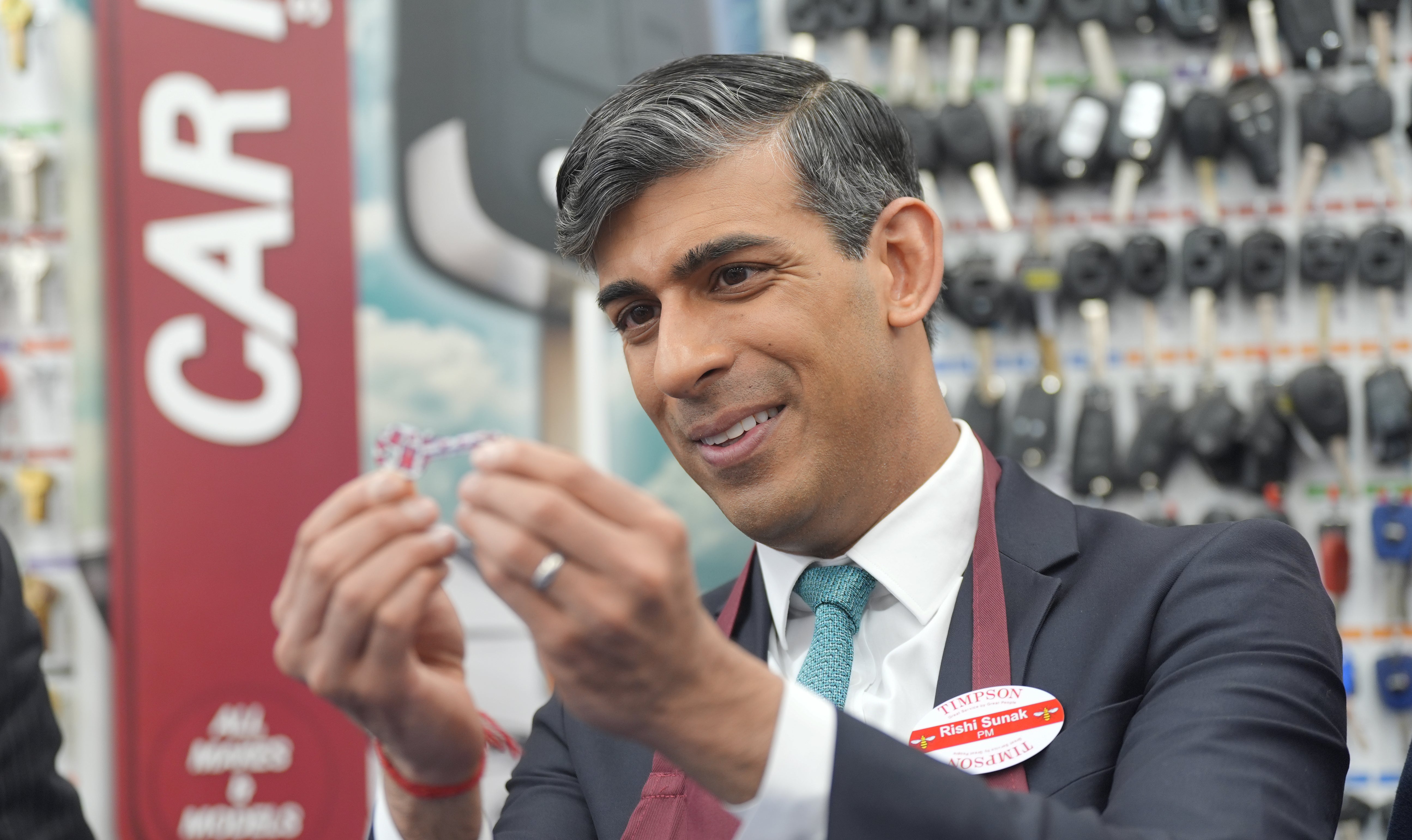 The PM visits a branch of Timpson after giving his speech on welfare reform in London on Friday