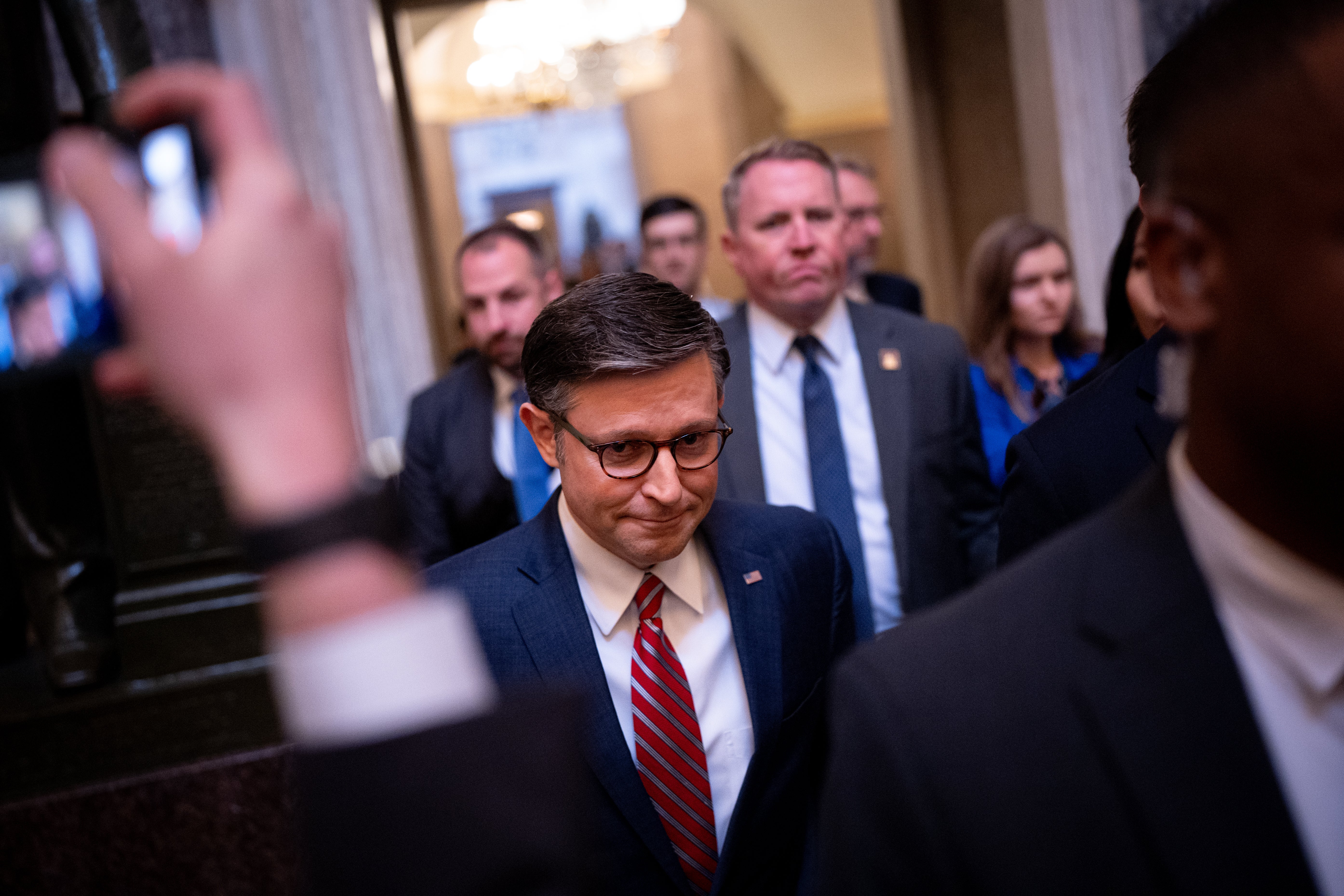 House Speaker Mike Johnson walks towards the House Chamber on Capitol Hill on Friday