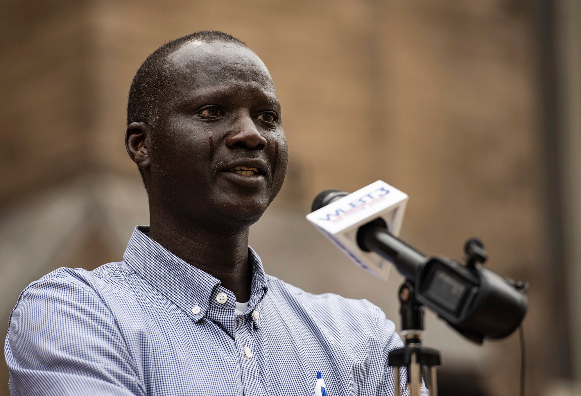 Bul Mabil has tears streaming down his face as he speaks during a press conference to ask for the public’s help