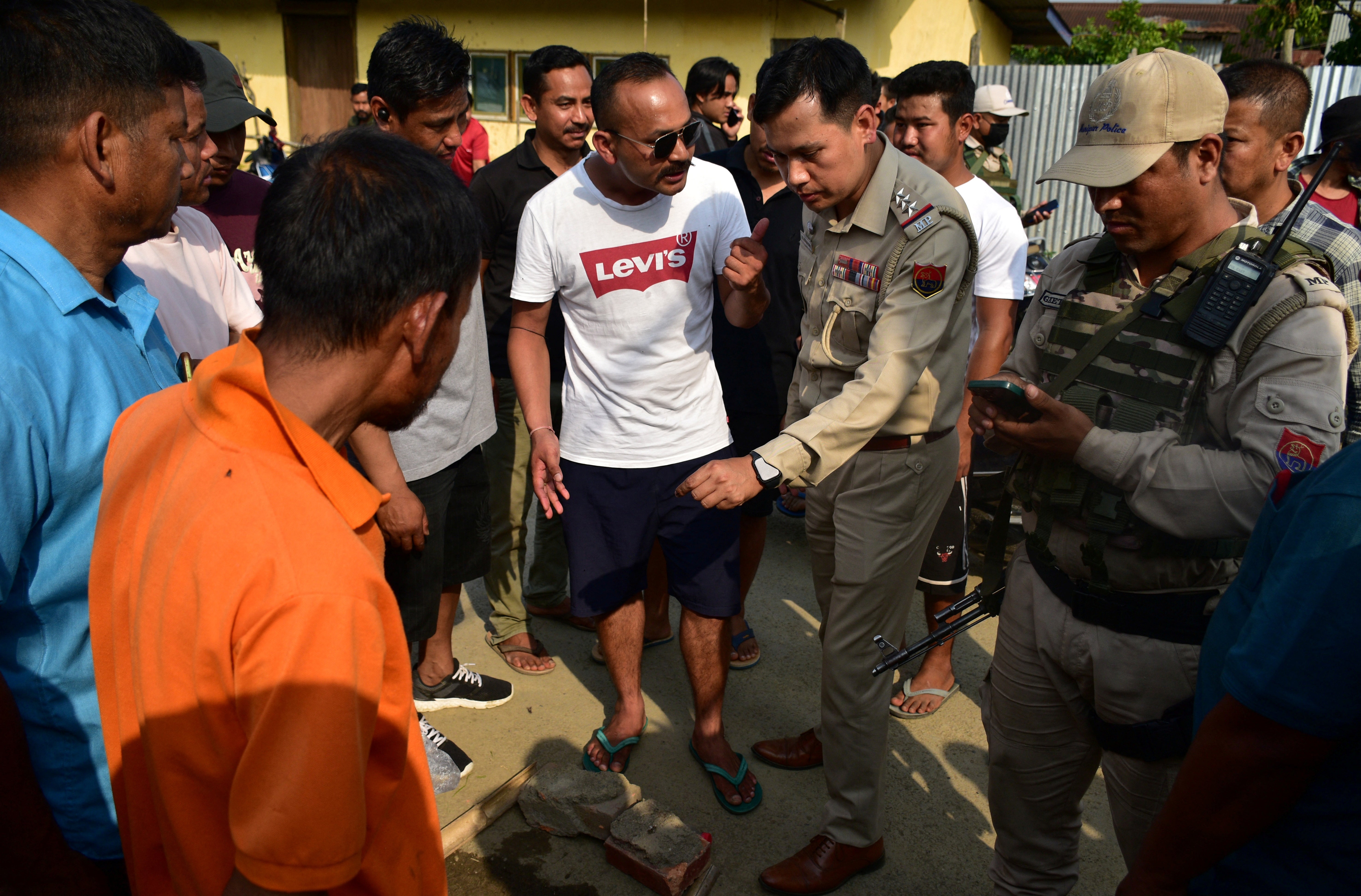 Police officers arrive at the scene of a shooting outside a polling station during the first phase of the general election, in Moirangkampu in Imphal East, Manipur