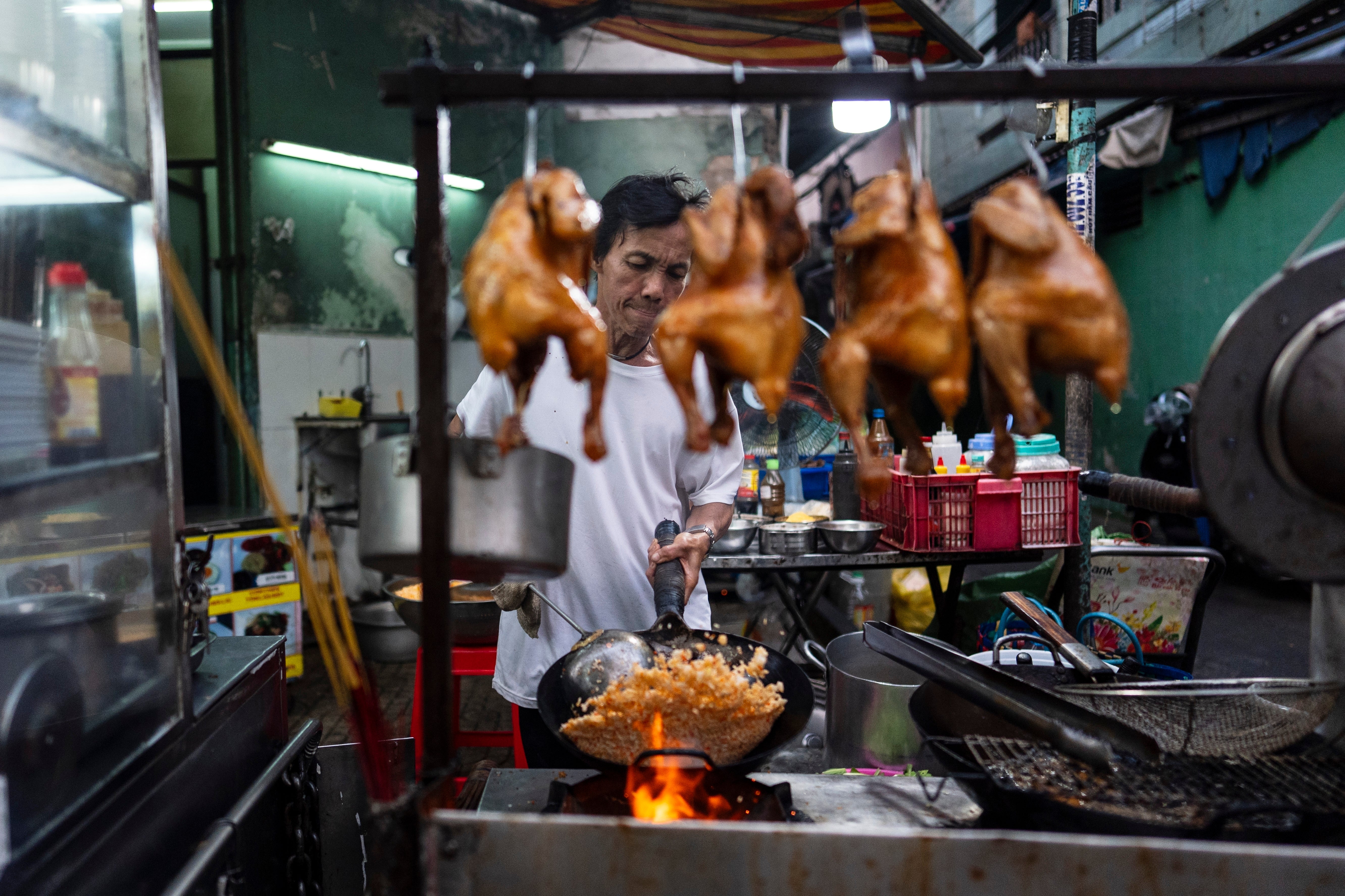 Restaurant owner Hien Ky prepares fried rice in Ho Chi Minh City, Vietnam