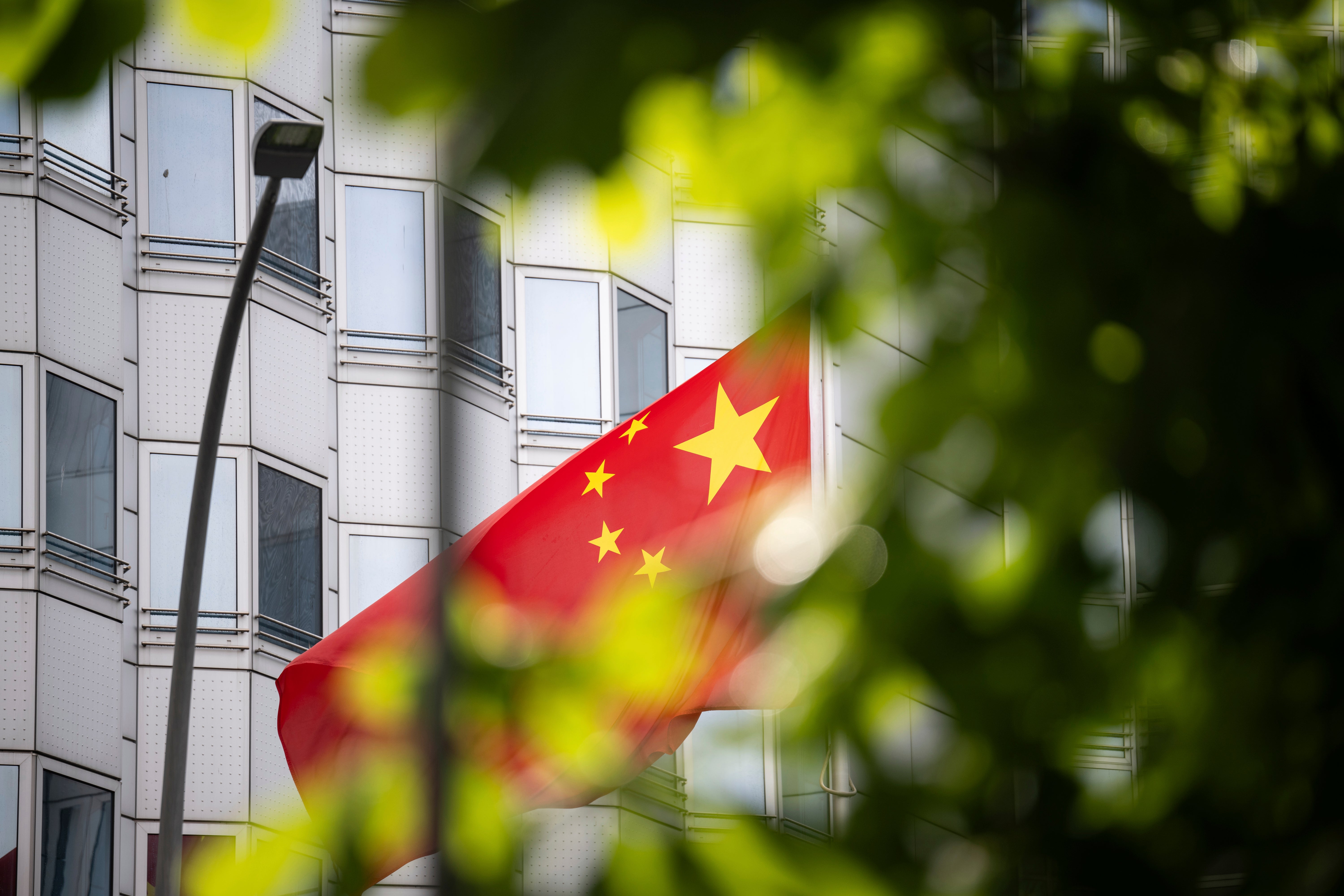 A country’s flag flies in front of the embassy of China in Berlin, Germany