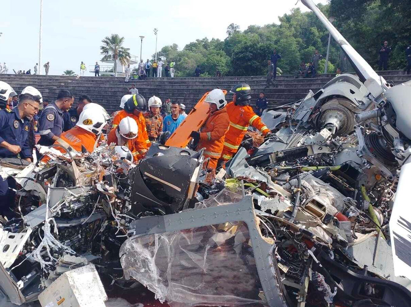 Malaysia fire and rescue department inspect the crash site of two helicopter in Lumur, Perak state