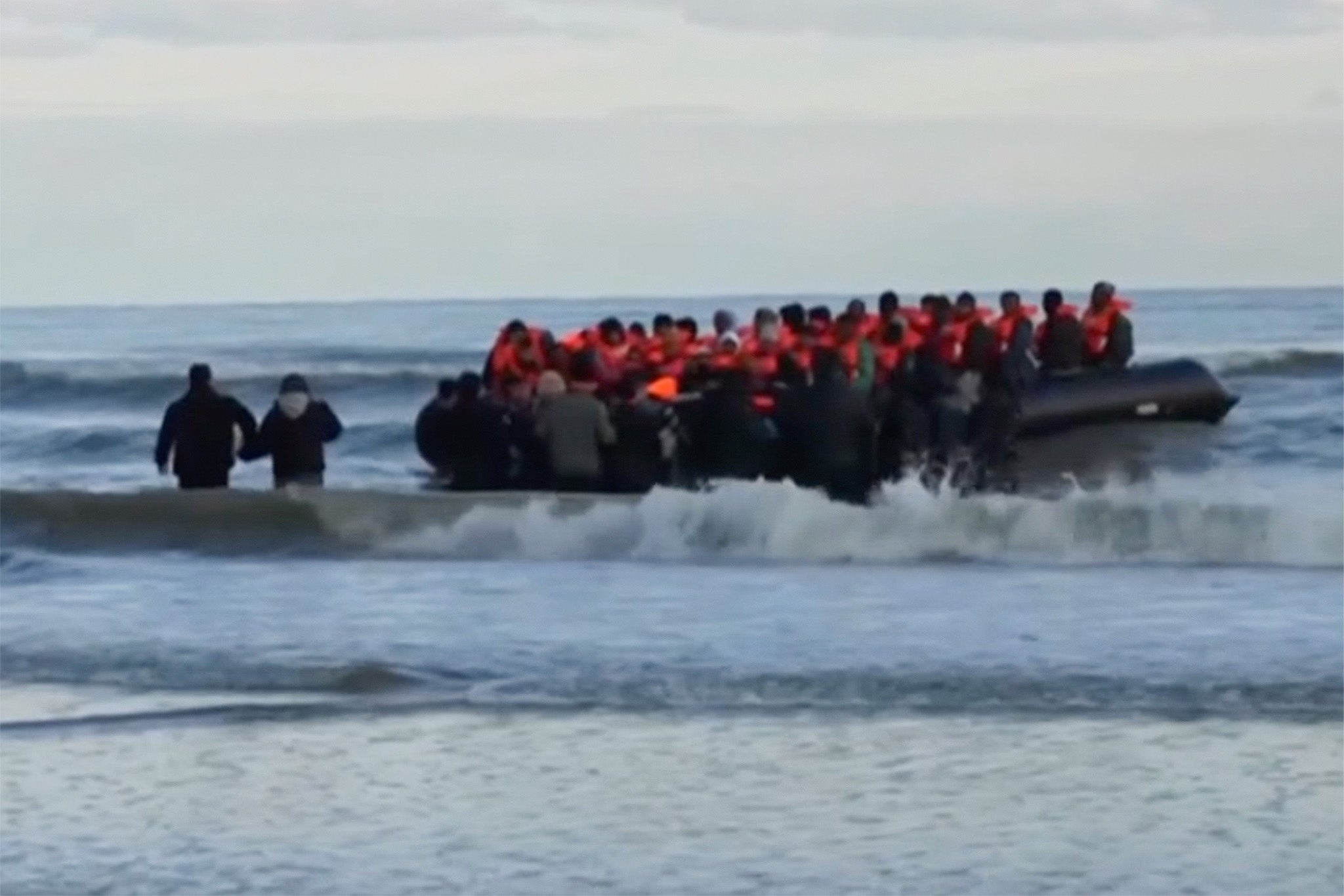 Footage from BBC News shows migrants in small boat at Dunkirk on Tuesday morning after the French coat guard confirmed at least five people had died attempting to cross the English Channel