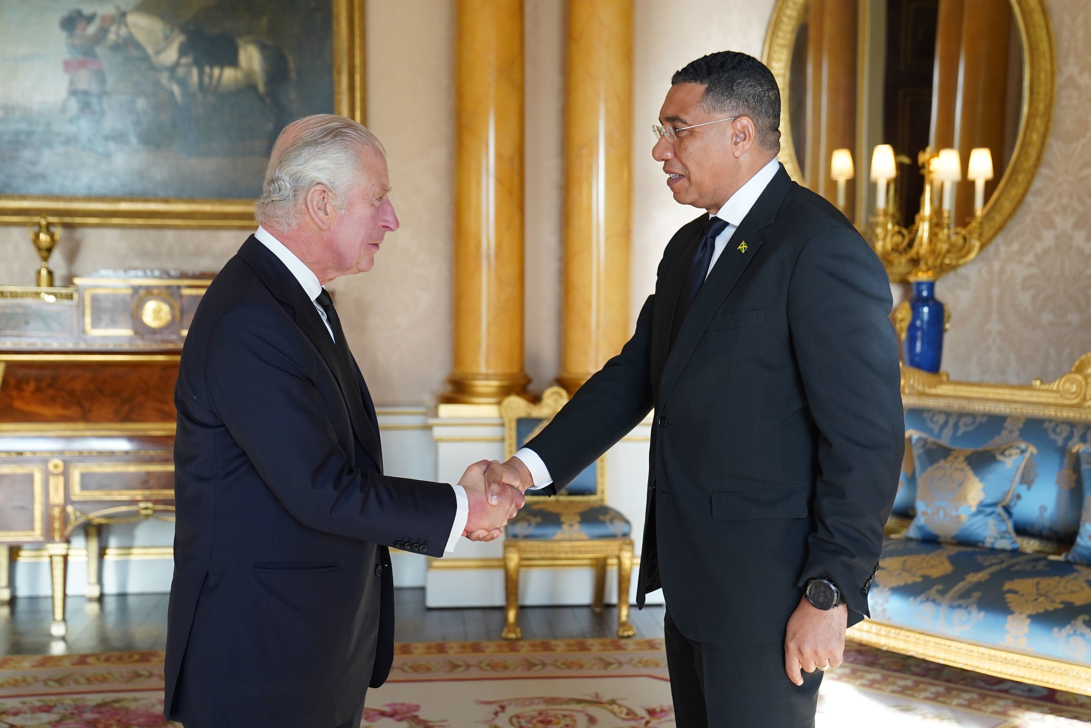 King Charles III speaks with the Prime Minister of Jamaica, Andrew Holness, at Buckingham Palace in September 2022