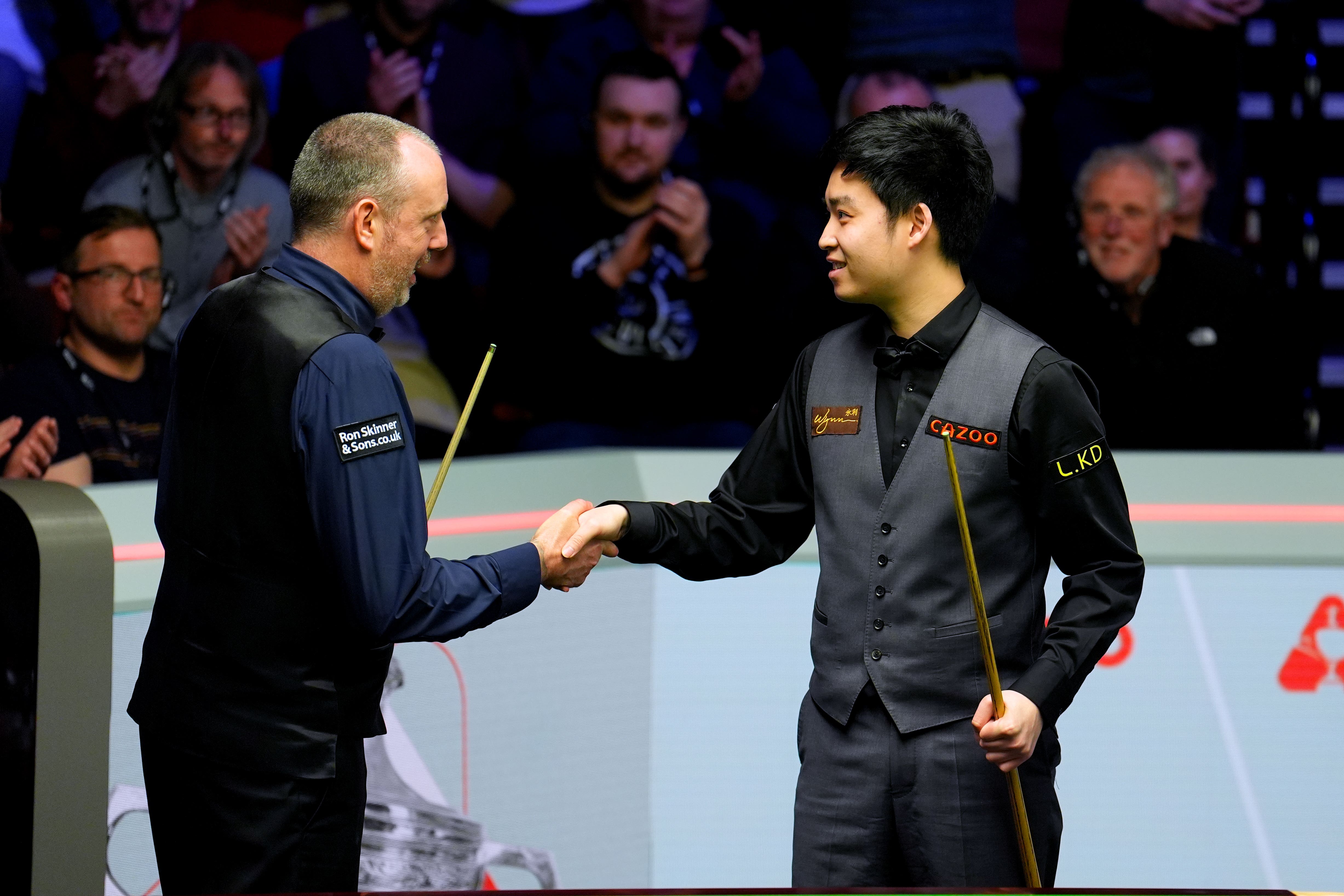 Mark Williams, left, was knocked out by Si Jiahui in the first round (Martin Rickett/PA)