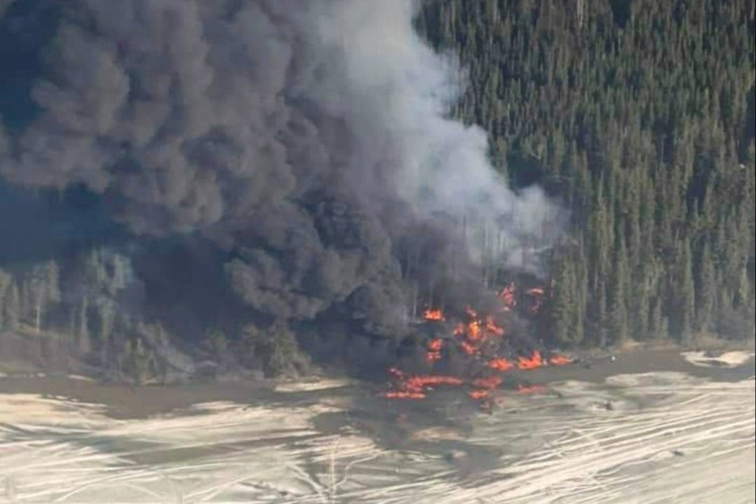 Two people confirmed to be on board Douglas DC-4 plane that crashed into river near Fairbanks, Alaska, and burst into flames