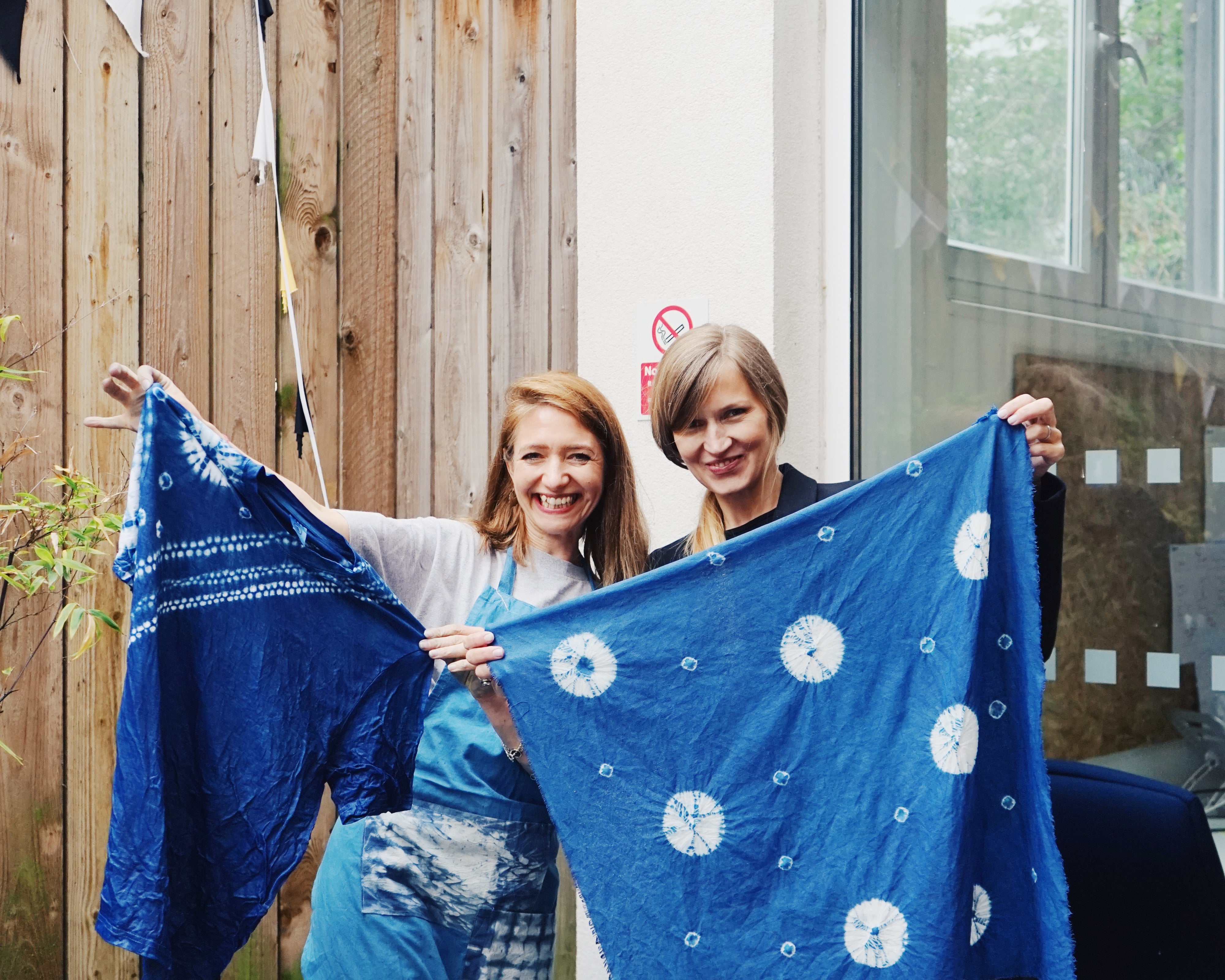 Two participants at one of Duan’s tie-dyeing workshops pose with completed work in London in March 2023