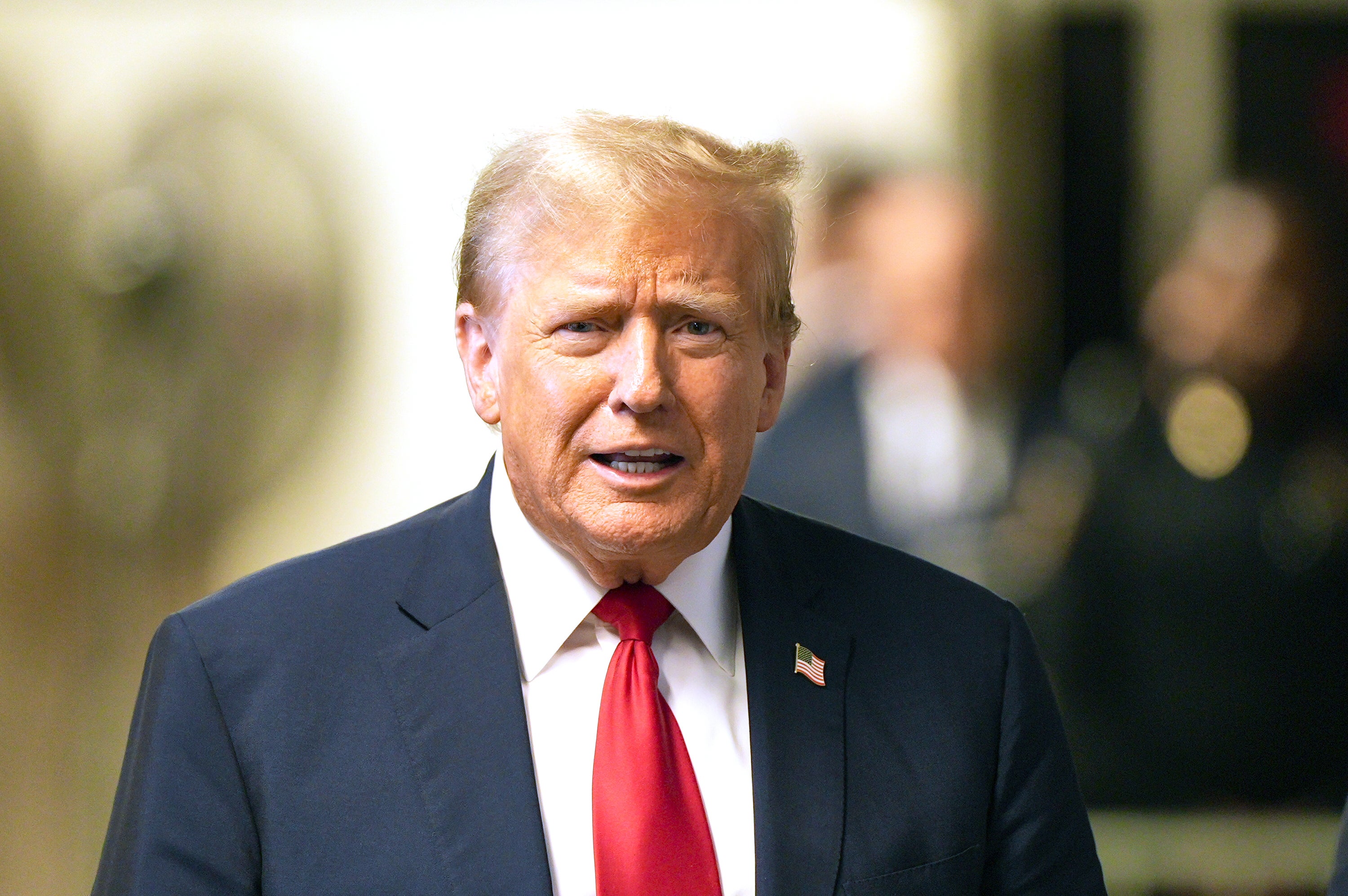 Donald Trump speaks to the media outside the courtroom during his trial