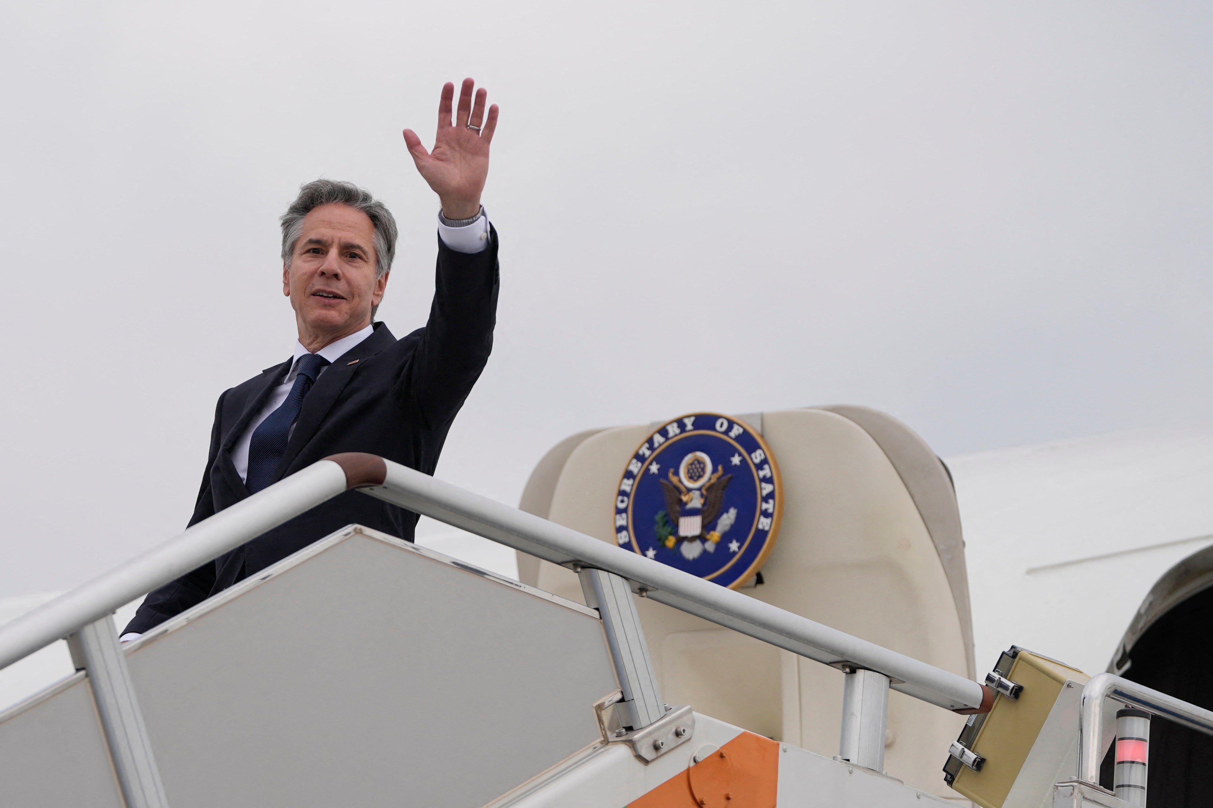 US Secretary of State Antony Blinken waves as he prepares to depart Shanghai Hongqiao International Airport en route to Beijing