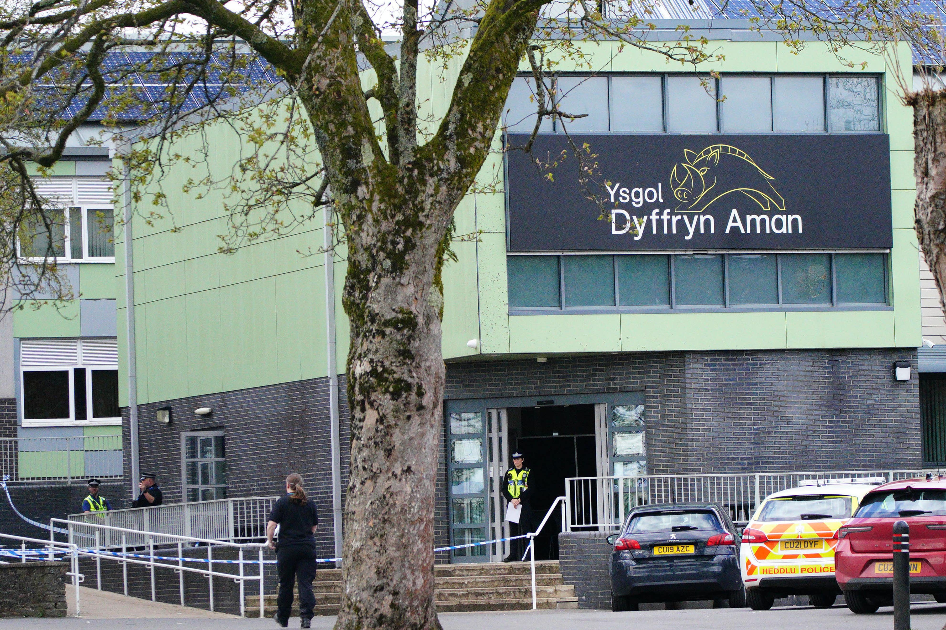 Police at Amman Valley school, in Ammanford, Carmarthenshire, after an arrest was made and three people injured at the school (Ben Birchall/PA)