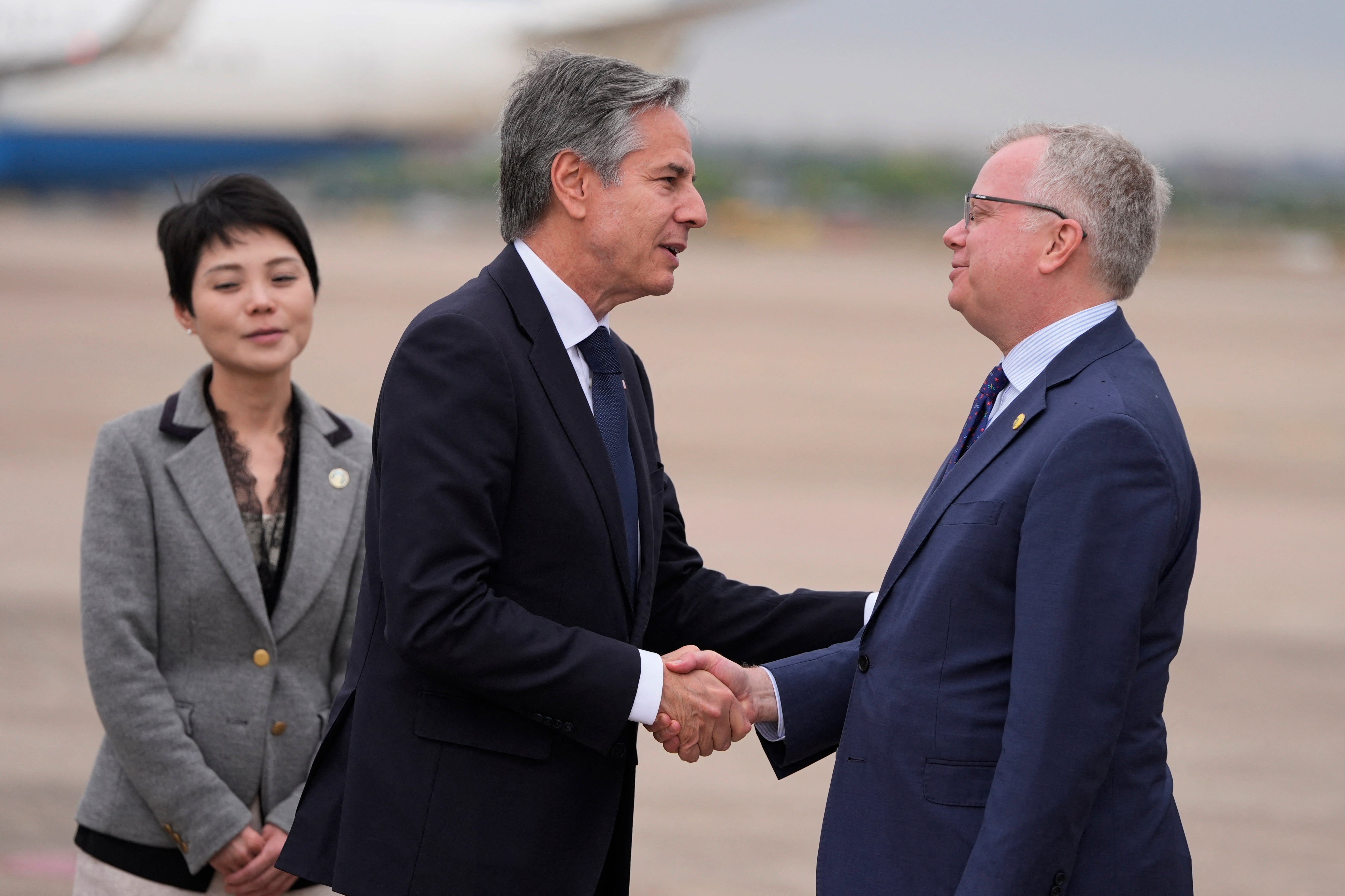 Antony Blinken shakes hands with Scott Walker, Consul General at the US Consulate General in Shanghai, after arriving in China