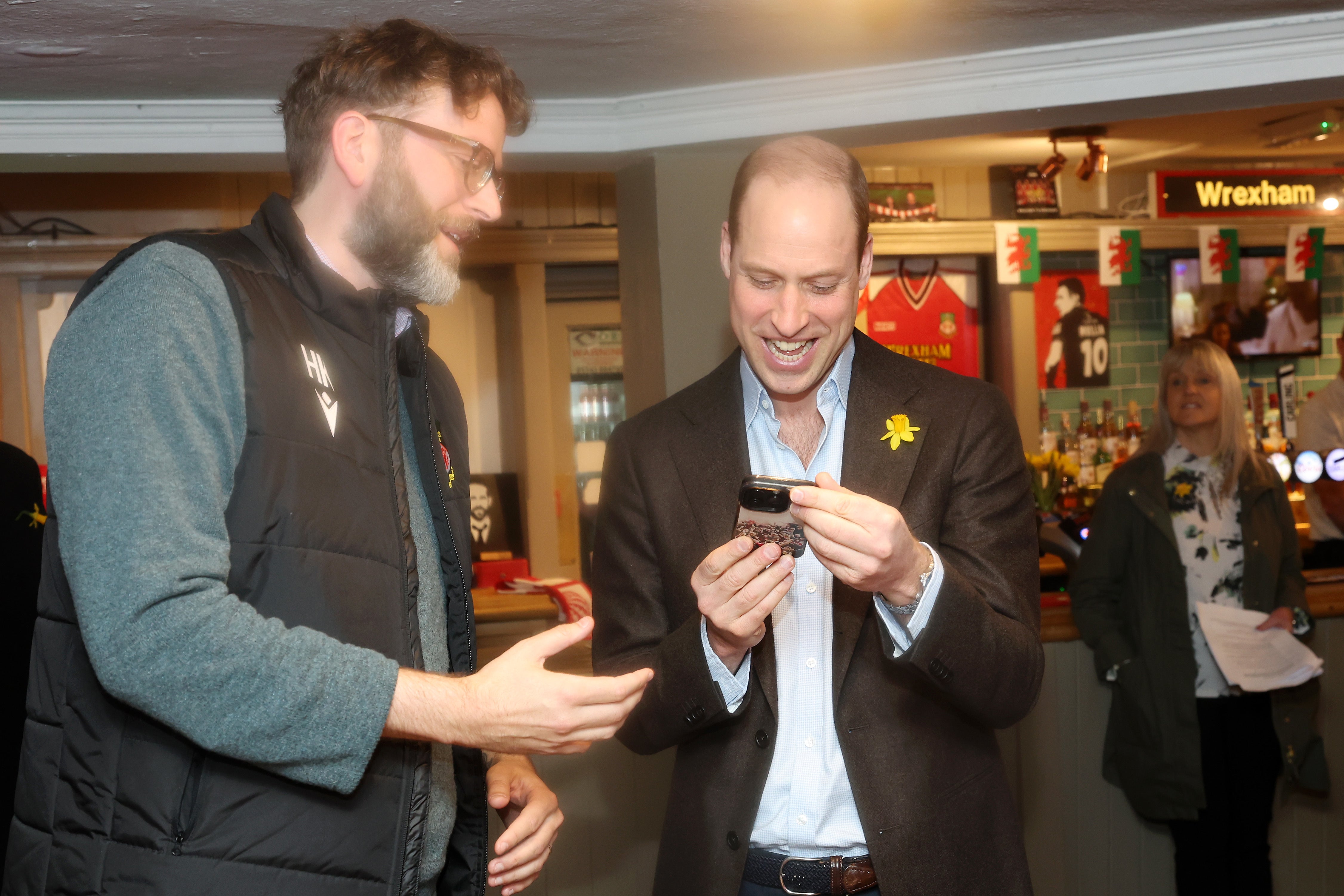 The Prince of Wales meets Executive Director of Wrexham AFC Humphrey Ker during a visit to The Turf public house at Wrexham AFC