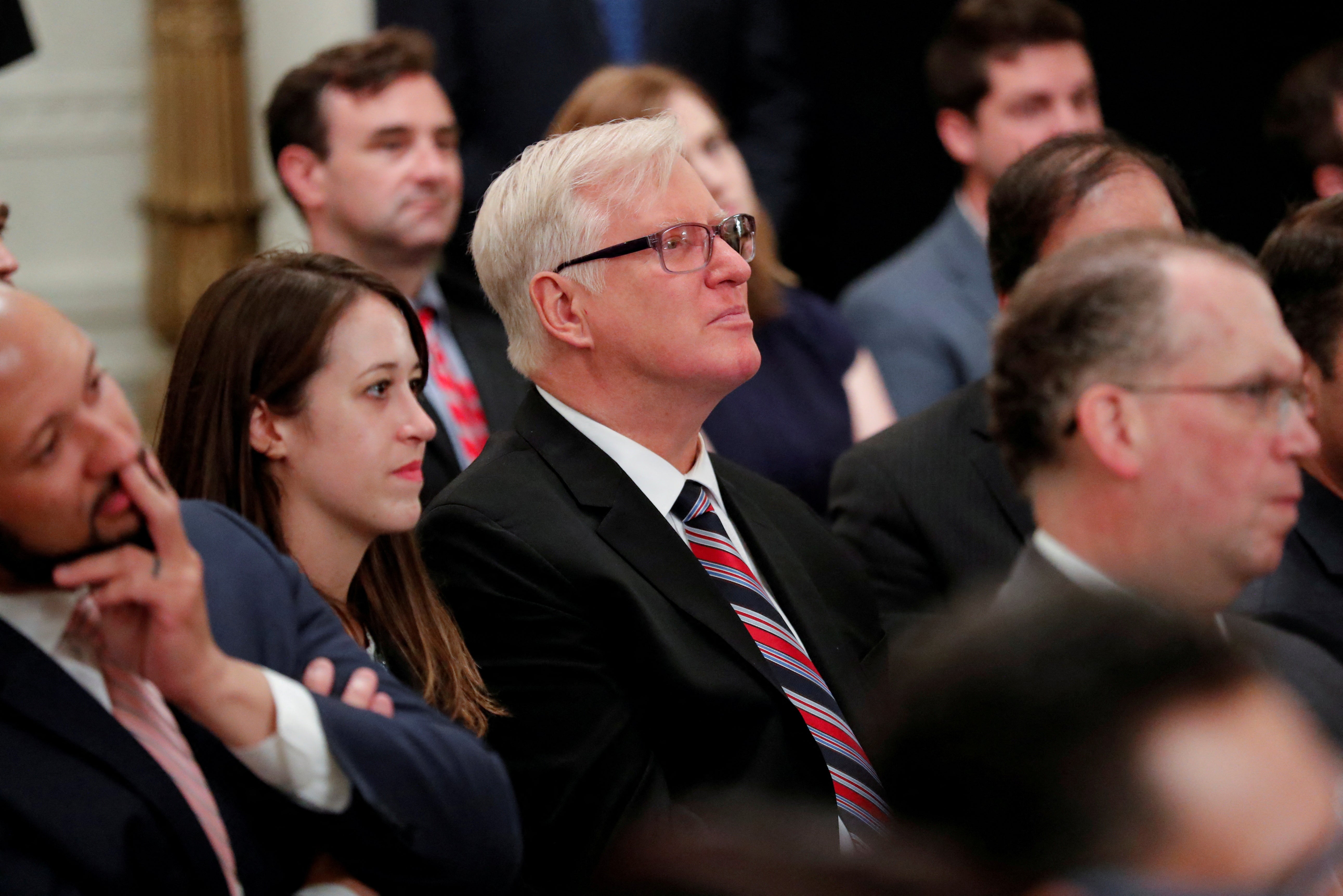 Gateway Pundit publisher Jim Hoft listens as Donald Trump speaks during a ‘social media summit'