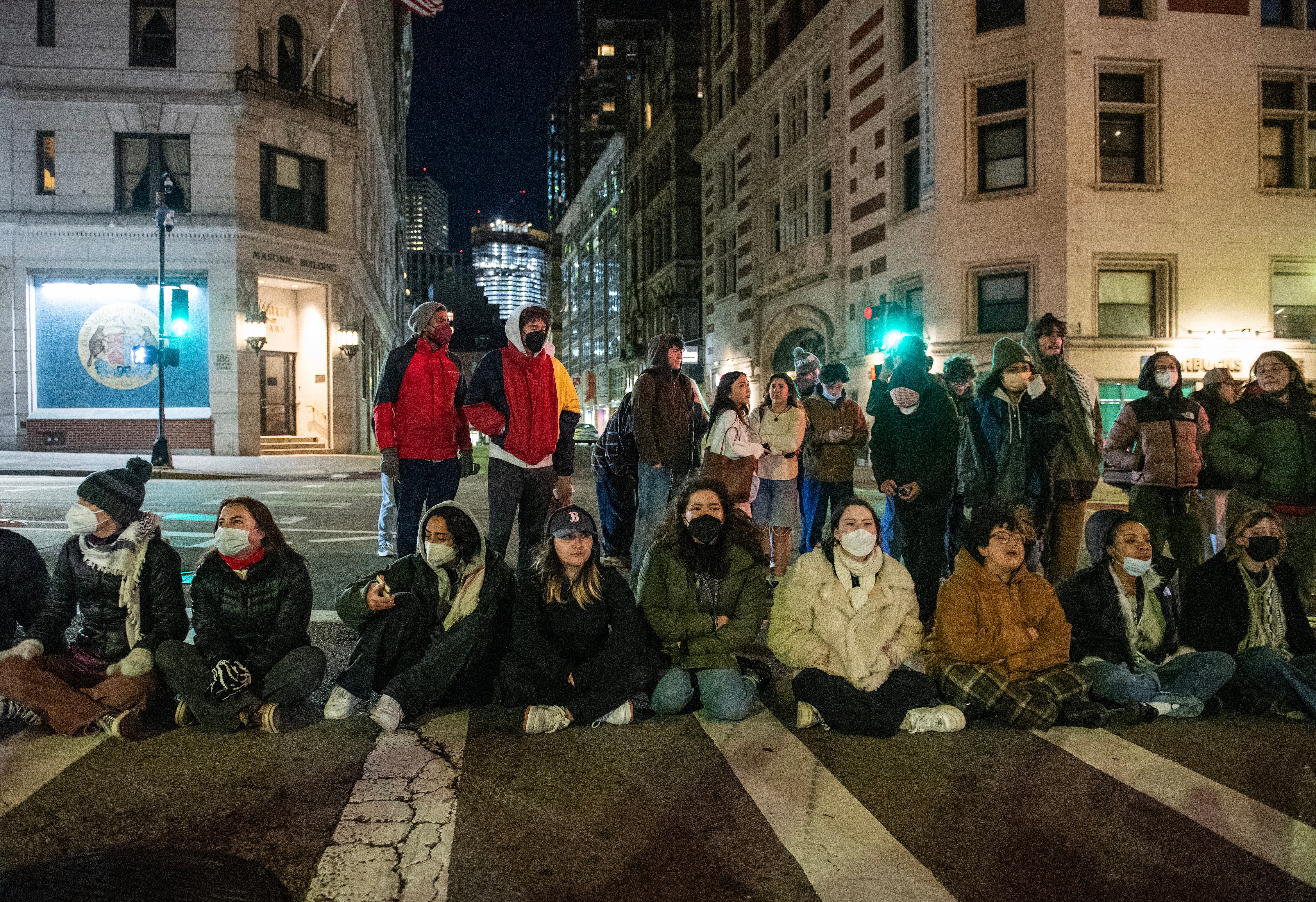 Pro-Palestinian supporters block a street as police deploy to clear their camp at Emerson College in Boston