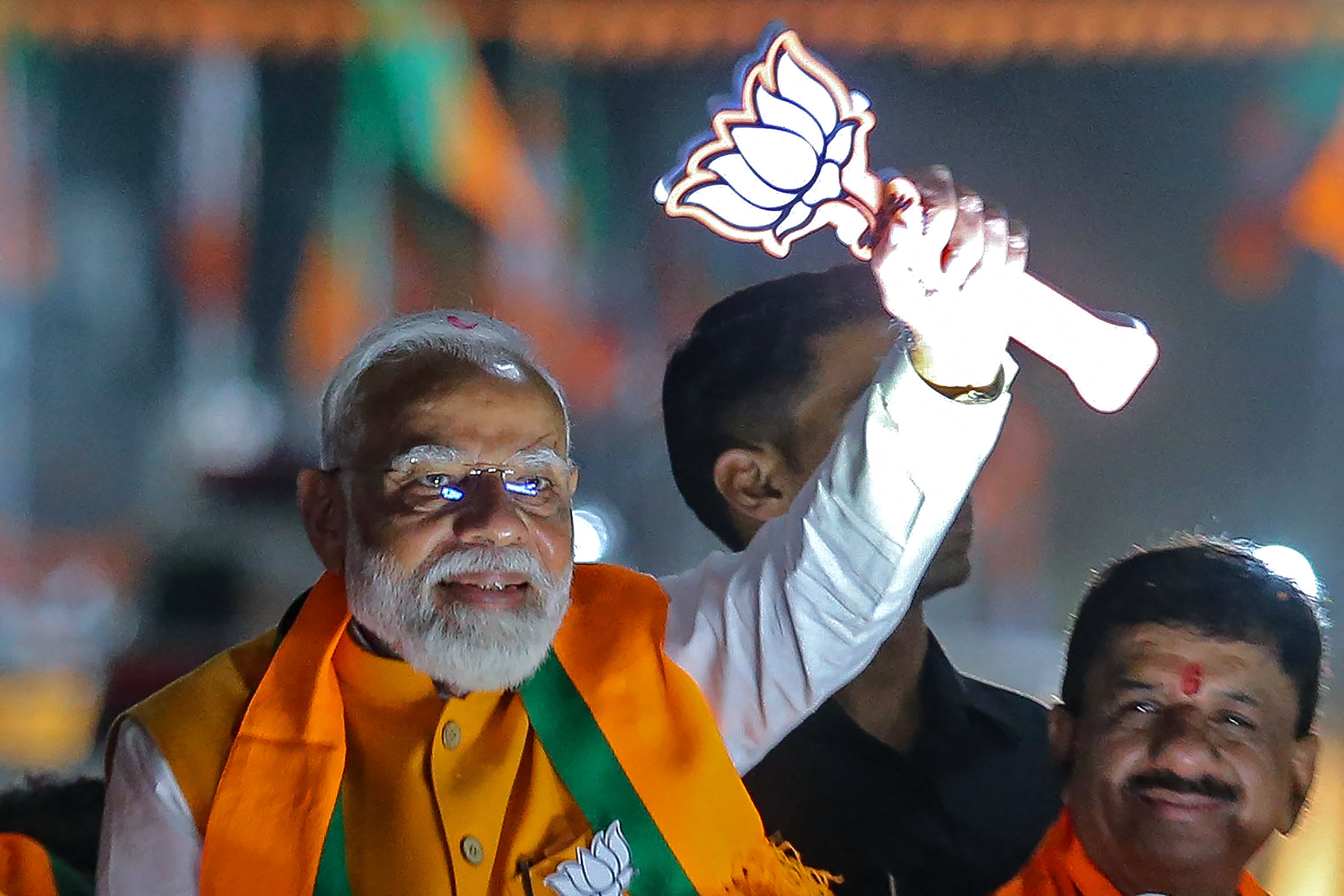 Narendra Modi greets his supporters during a roadshow in Bhopal