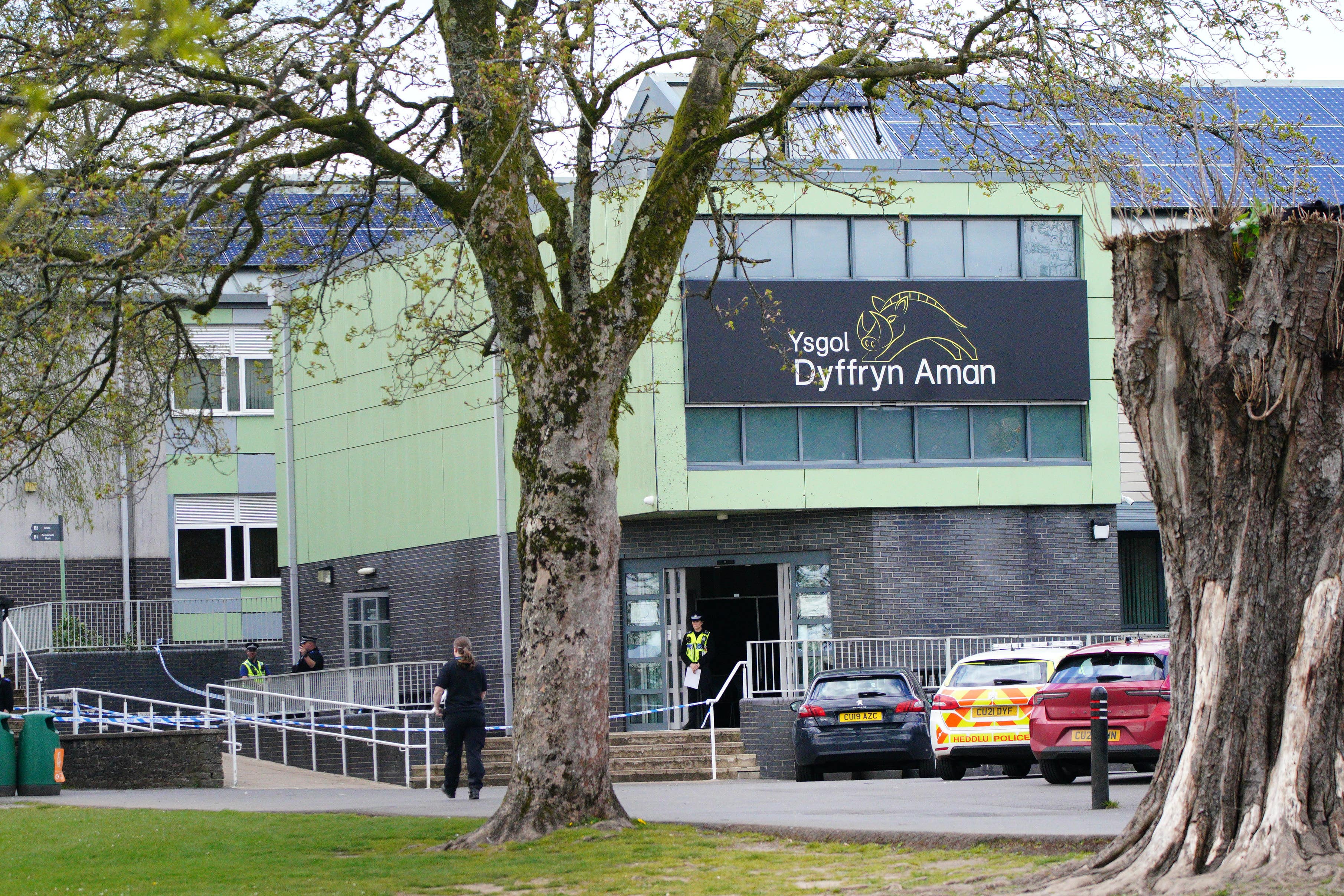 Police at Amman Valley school, in Ammanford, Carmarthenshire (PA)