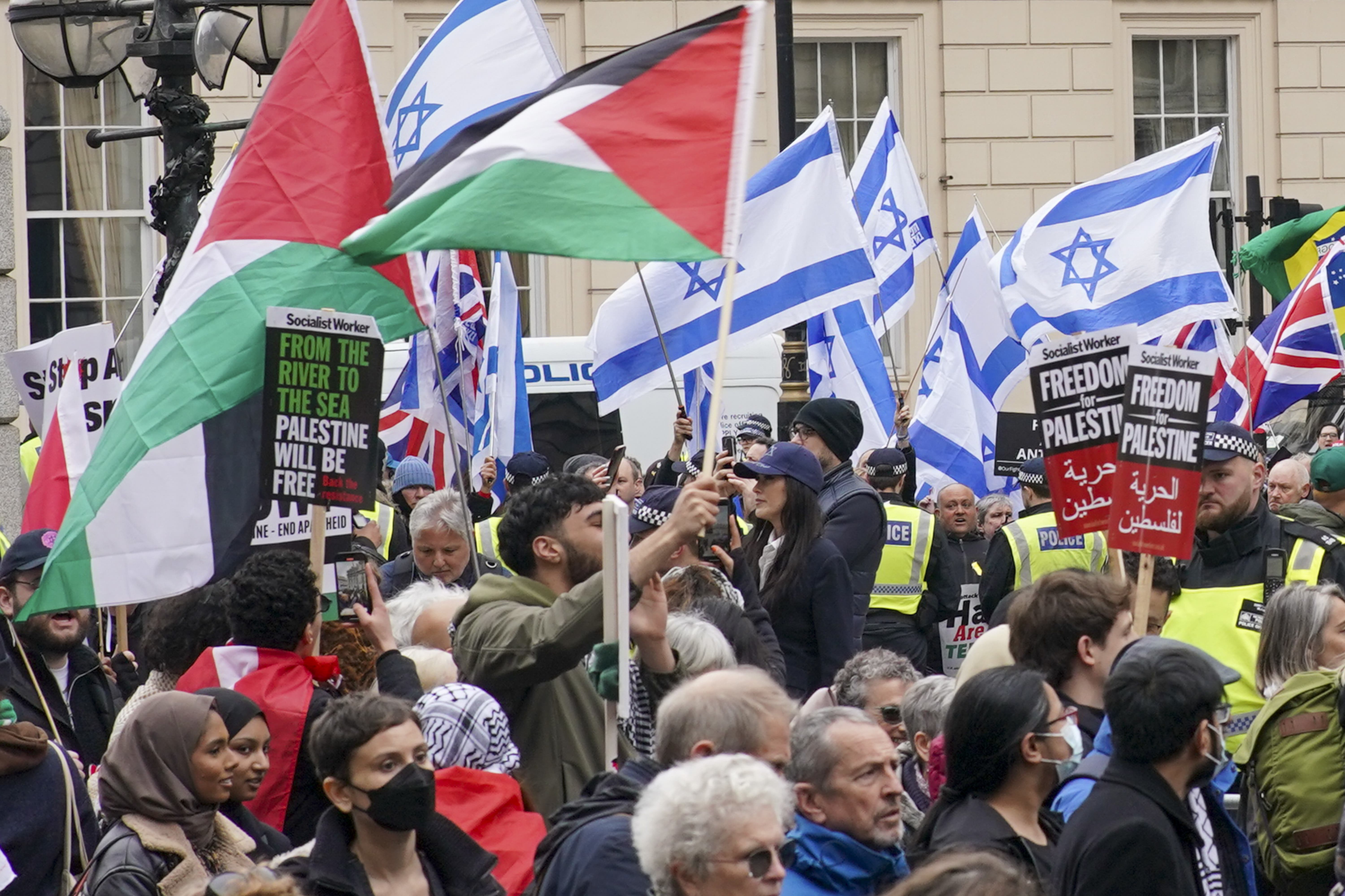 People take part in a pro-Palestine march as they walk past a counter protest (Jeff Moore/PA)