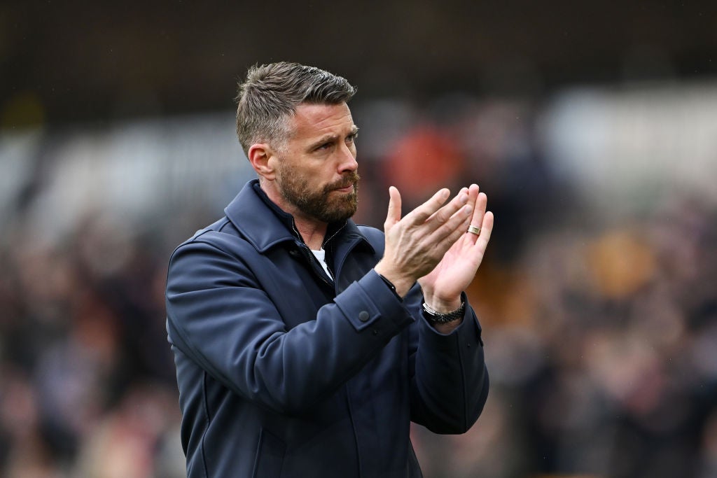 Rob Edwards, Manager of Luton Town, applauds the fans after the team's defeat