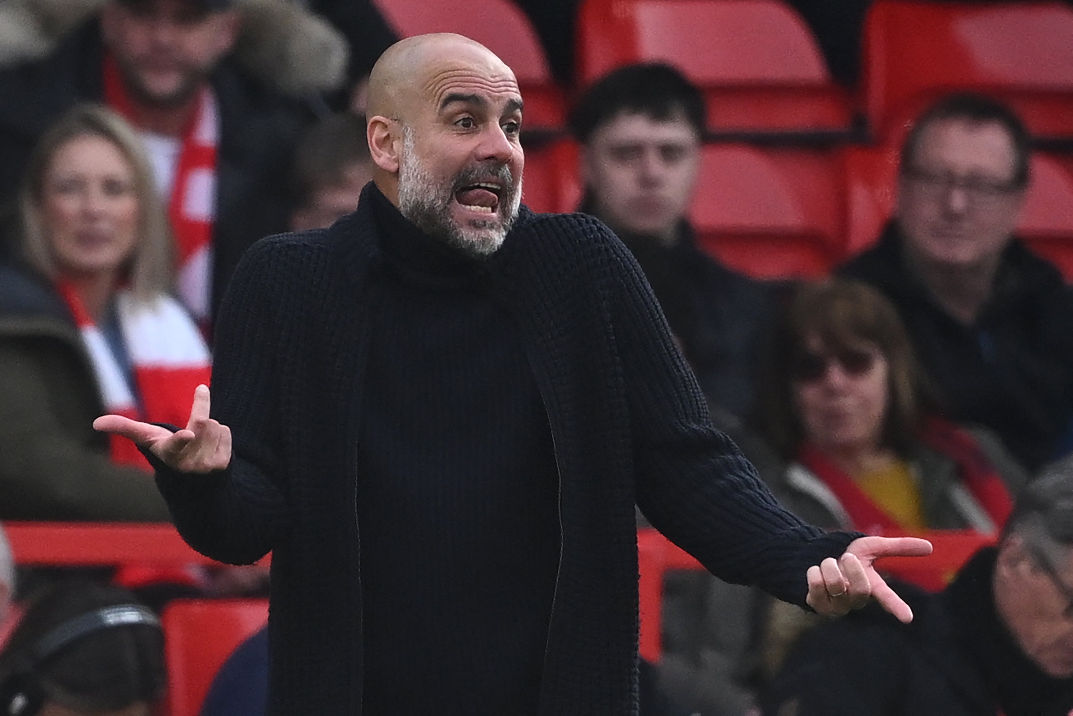 Pep Guardiola gestures on the touchline