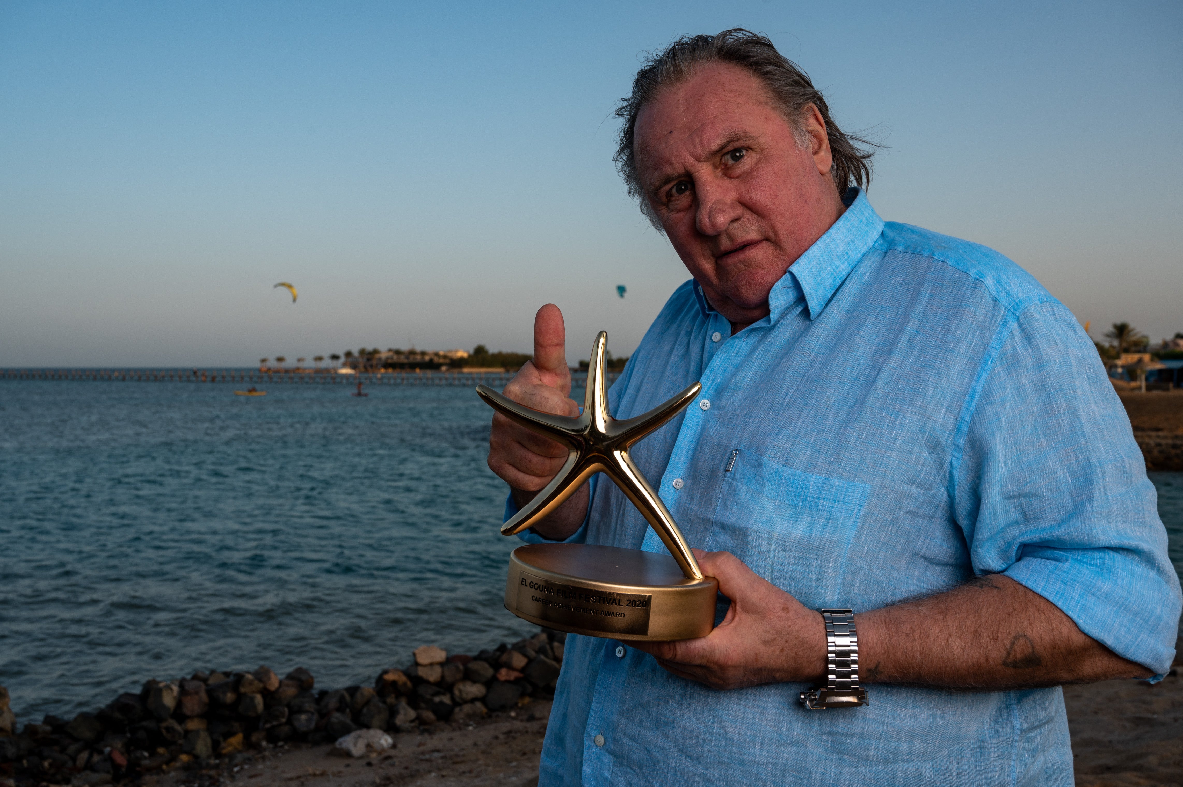 Depardieu poses after receiving a Career Achievement Award in 2020