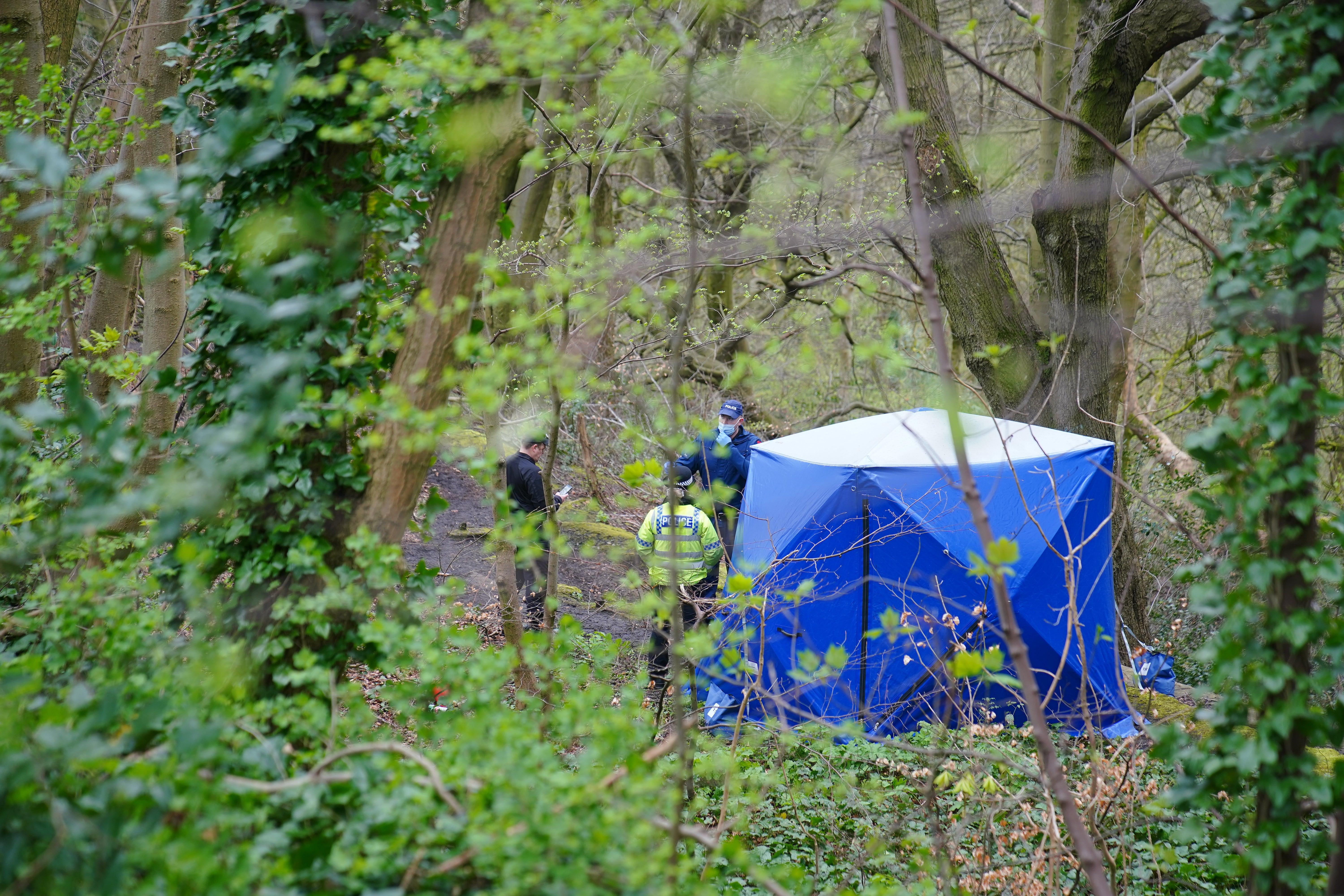 Police officers by a forensic tent at Kersal Dale, near Salford, Greater Manchesterr, last April