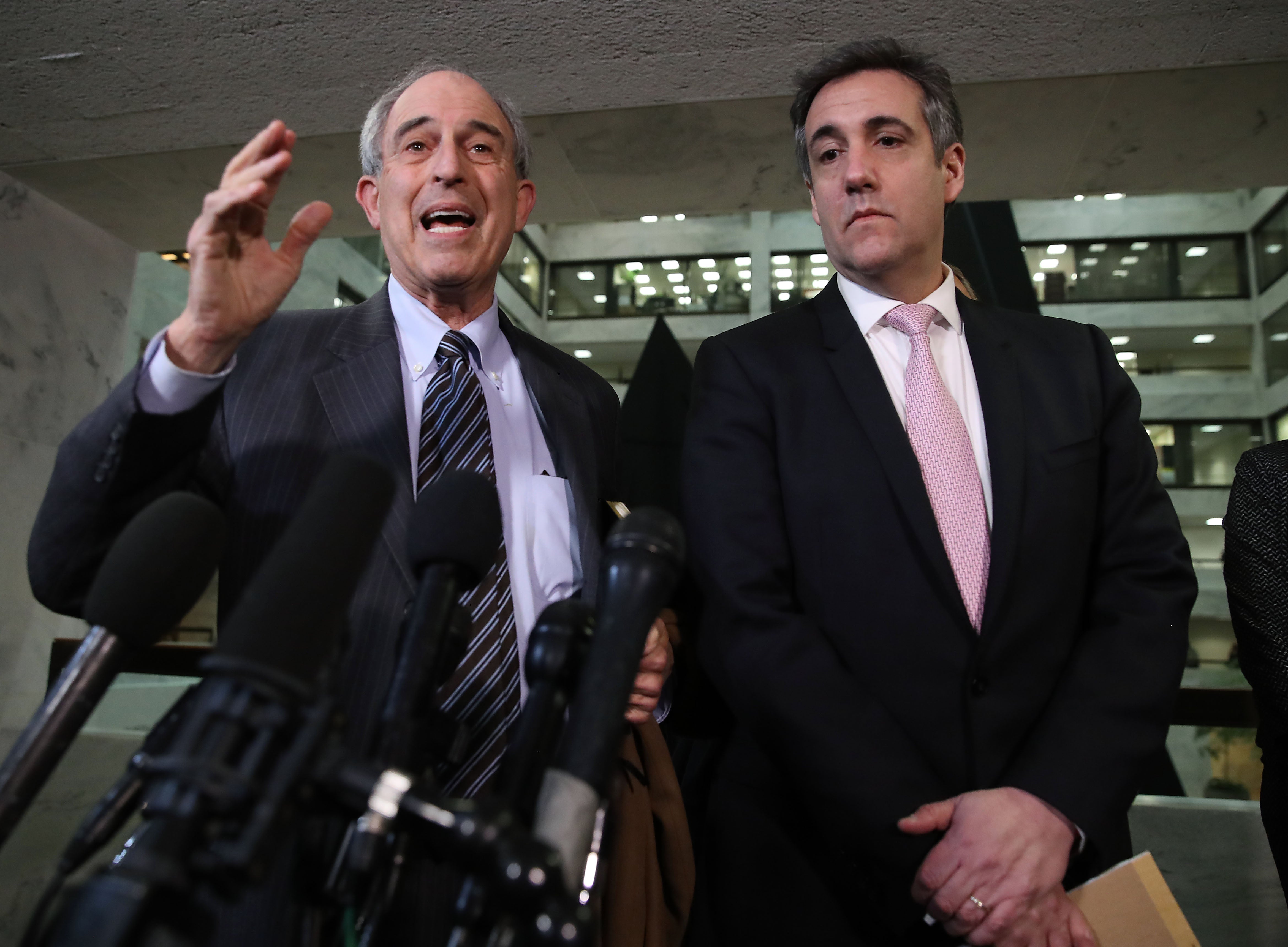 Mr Davis speaks with Cohen after he testified to the Senate Intelligence Committee on Capitol Hill on 26 February 2019, where he unveiled information that is now being used in the hush money case