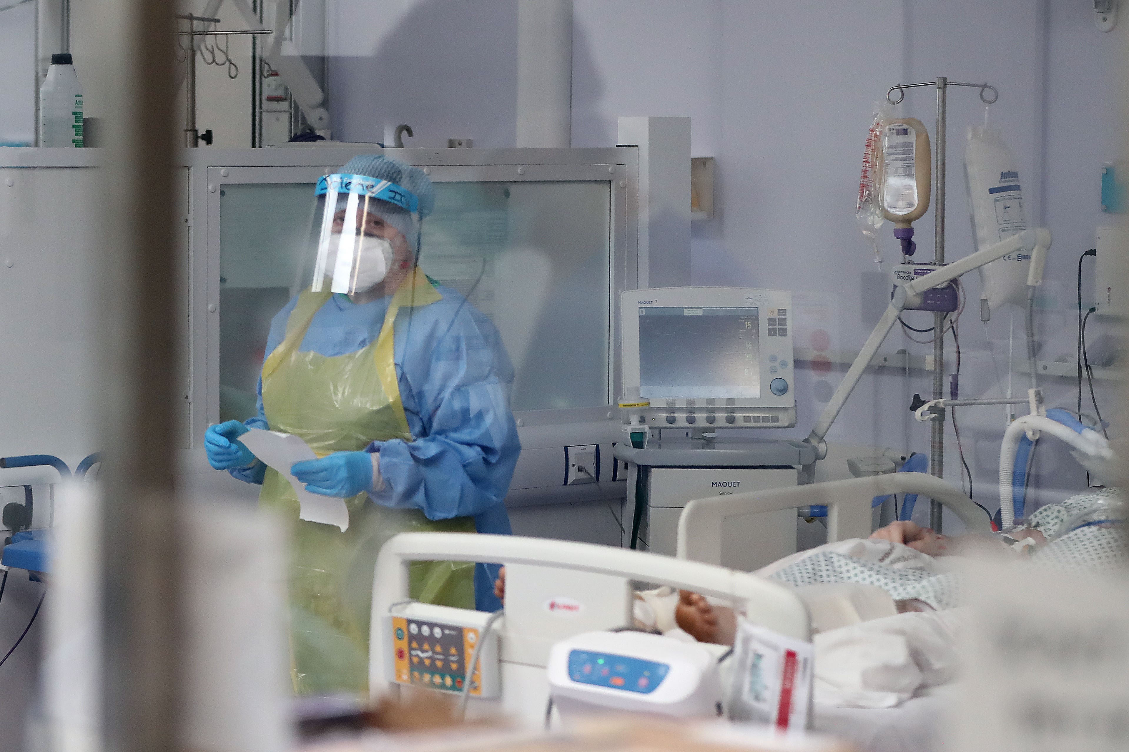 A member of the intensive care team treats Covid-19 patients at Craigavon Area Hospital in May 2020 (Niall Carson/PA)