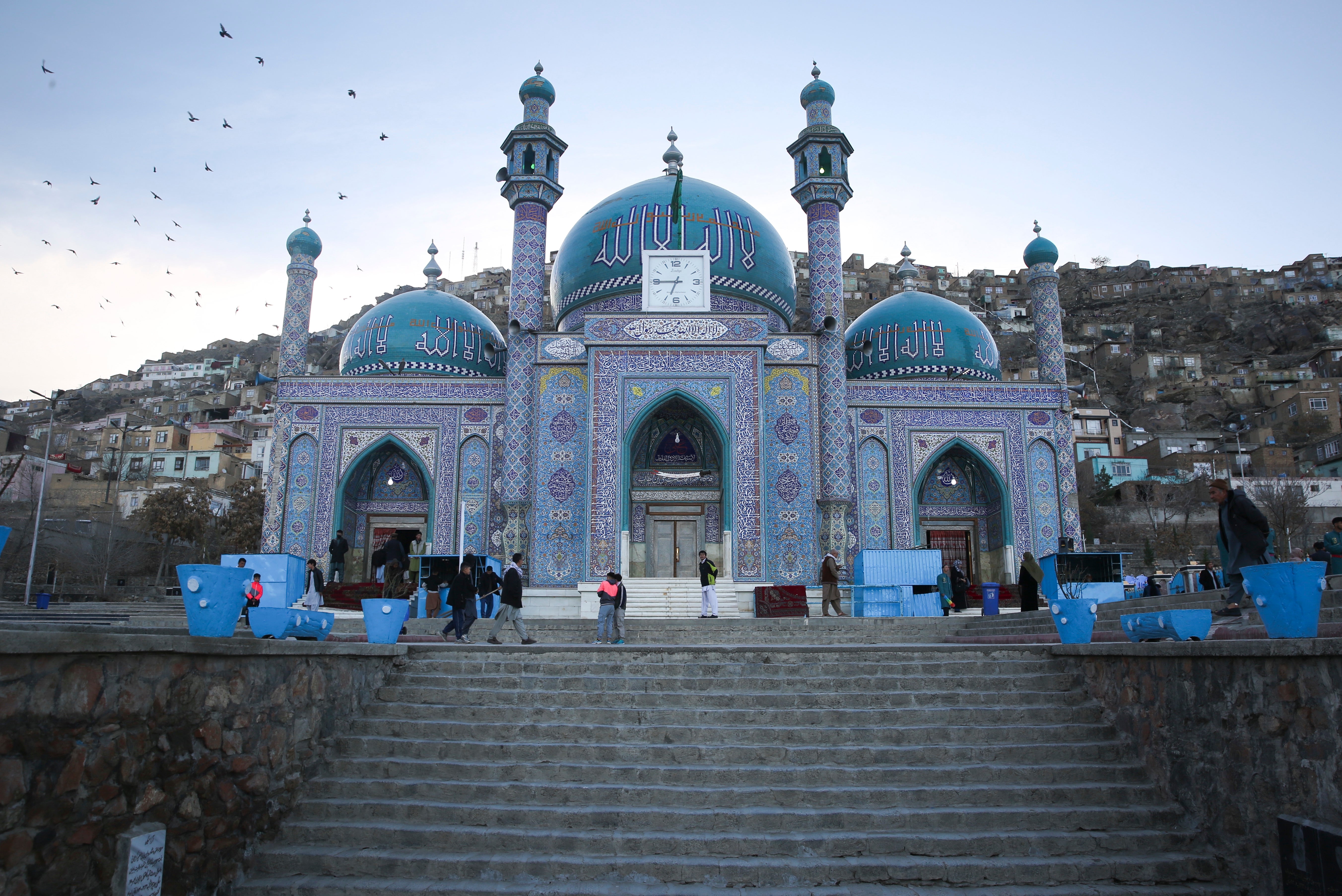 Afghans walk outside Hazara’s Sakhi Shrine in Kabul, Afghanistan