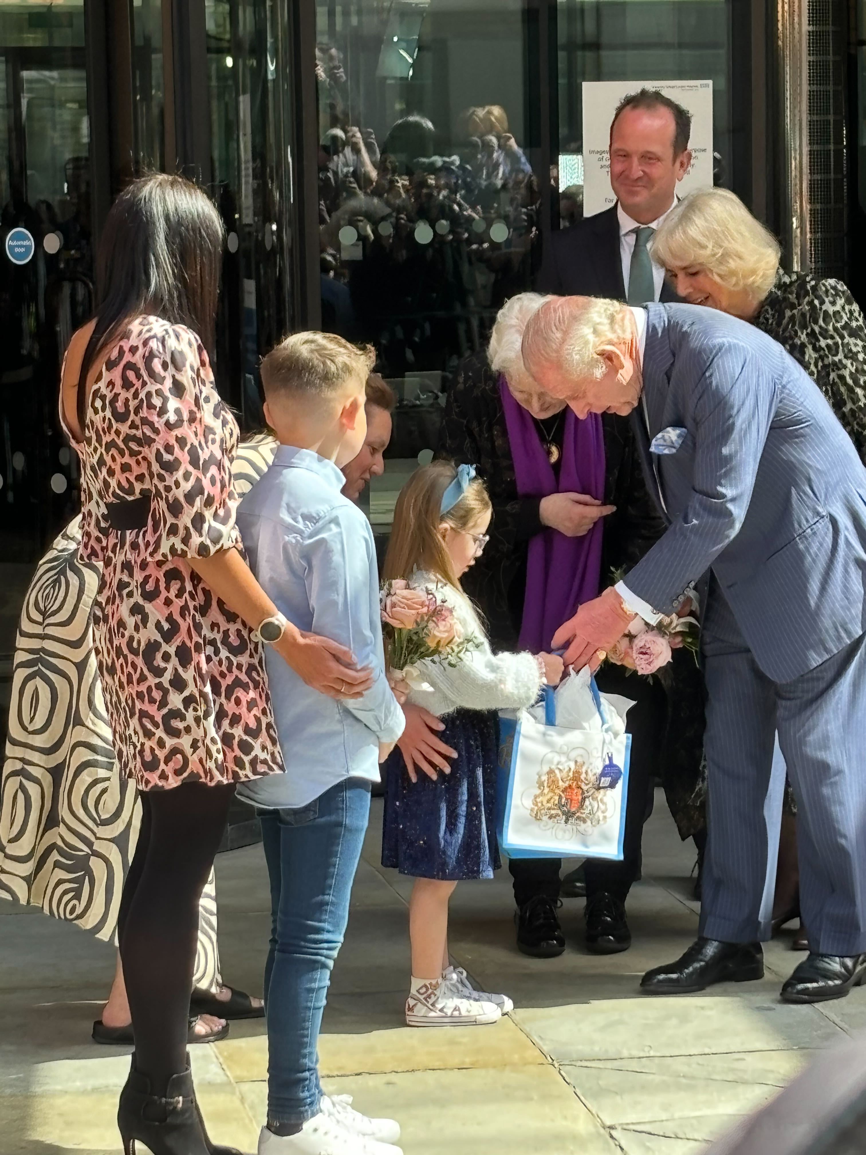 King Charles and Queen Camilla speak to young children as they left the University College Hospital Macmillan Cancer Centre in London in April