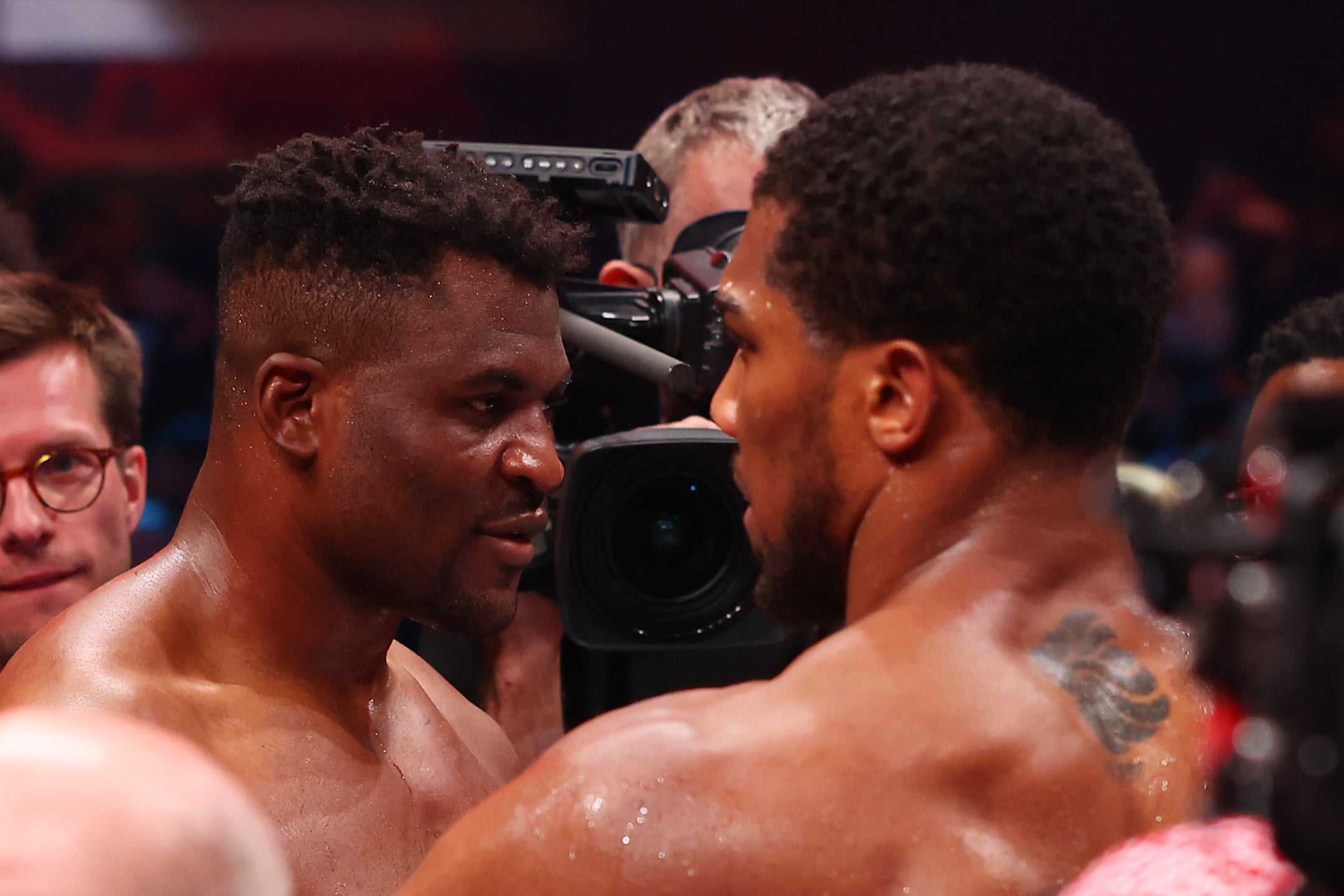 Anthony Joshua (right) consoling Francis Ngannou after beating him via knockout