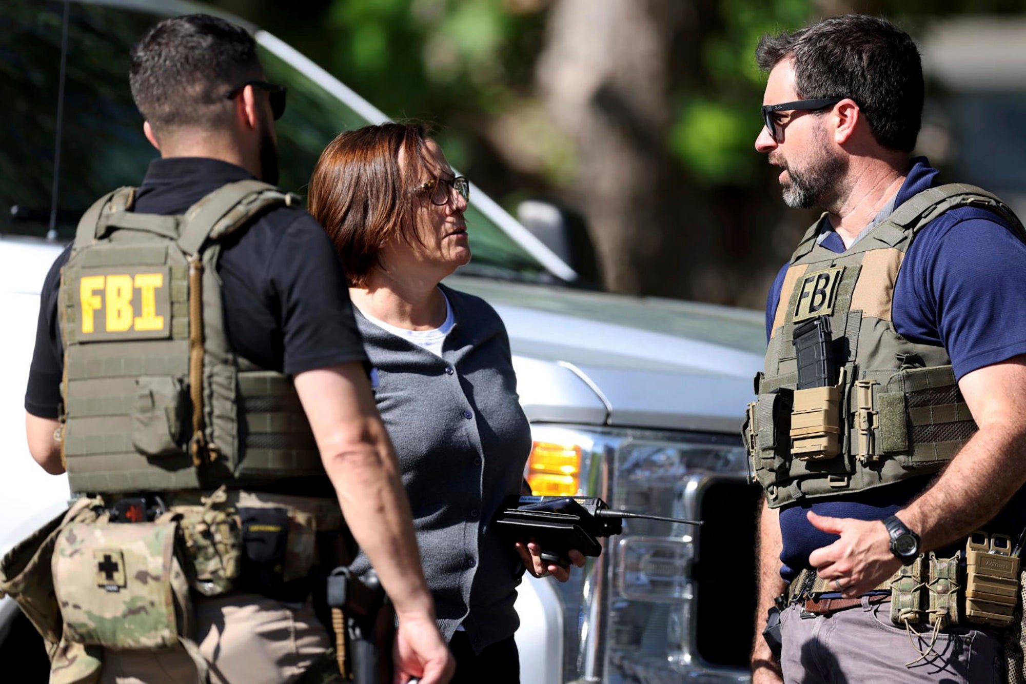 Members of FBI talk with each other at the scene of a shooting on Galway Drive in Charlotte, N.C., on Monday, April 29, 2024, Multiple law enforcement officers were shot while serving a warrant for a felon wanted for possessing a firearm.