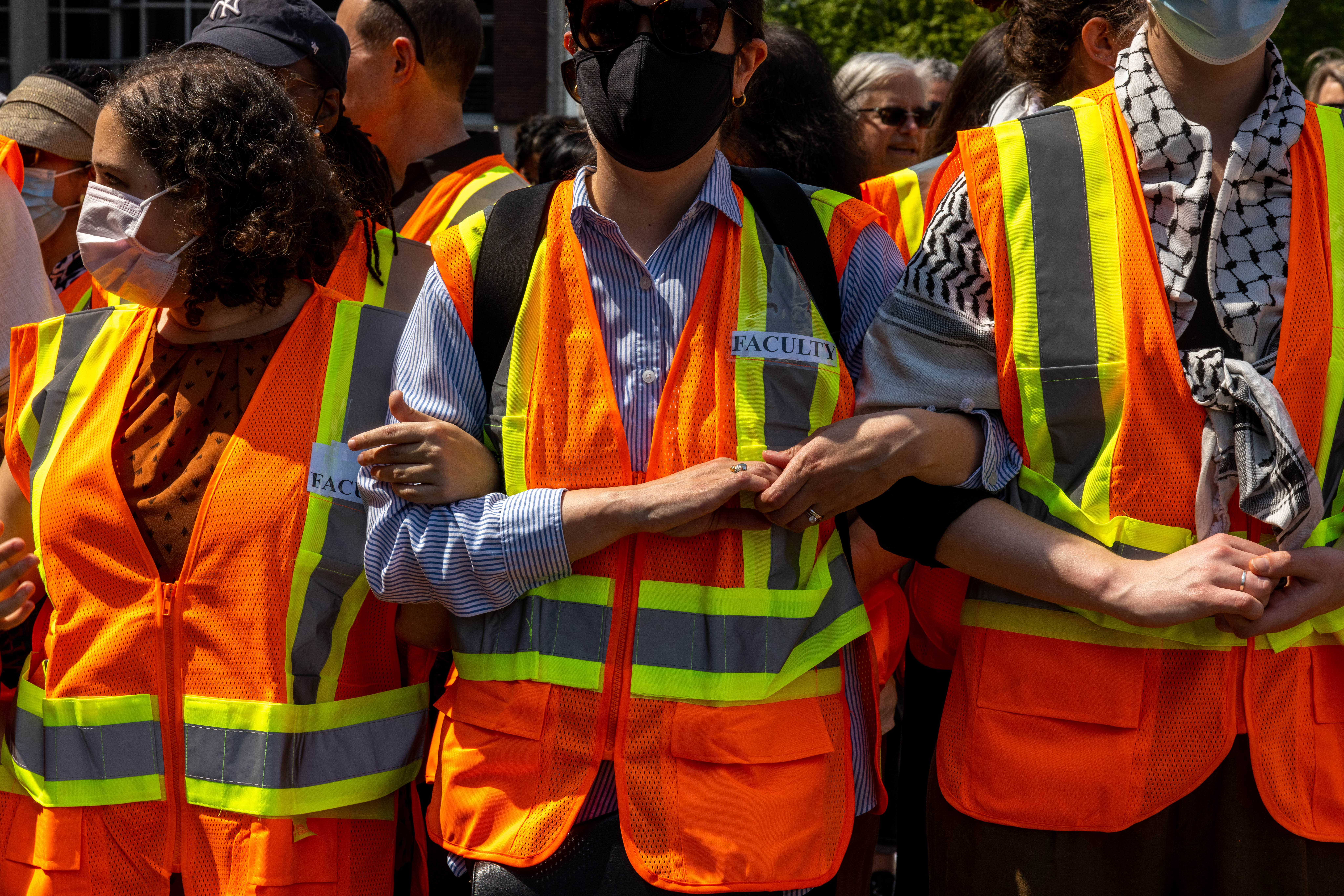 Faculty of Columbia University link arms to protect students inside threatened with suspension if they refused to voluntarily dismantle the pro-Palestine encampment on campus by 2 pm on April 29, 2024 in New York City.